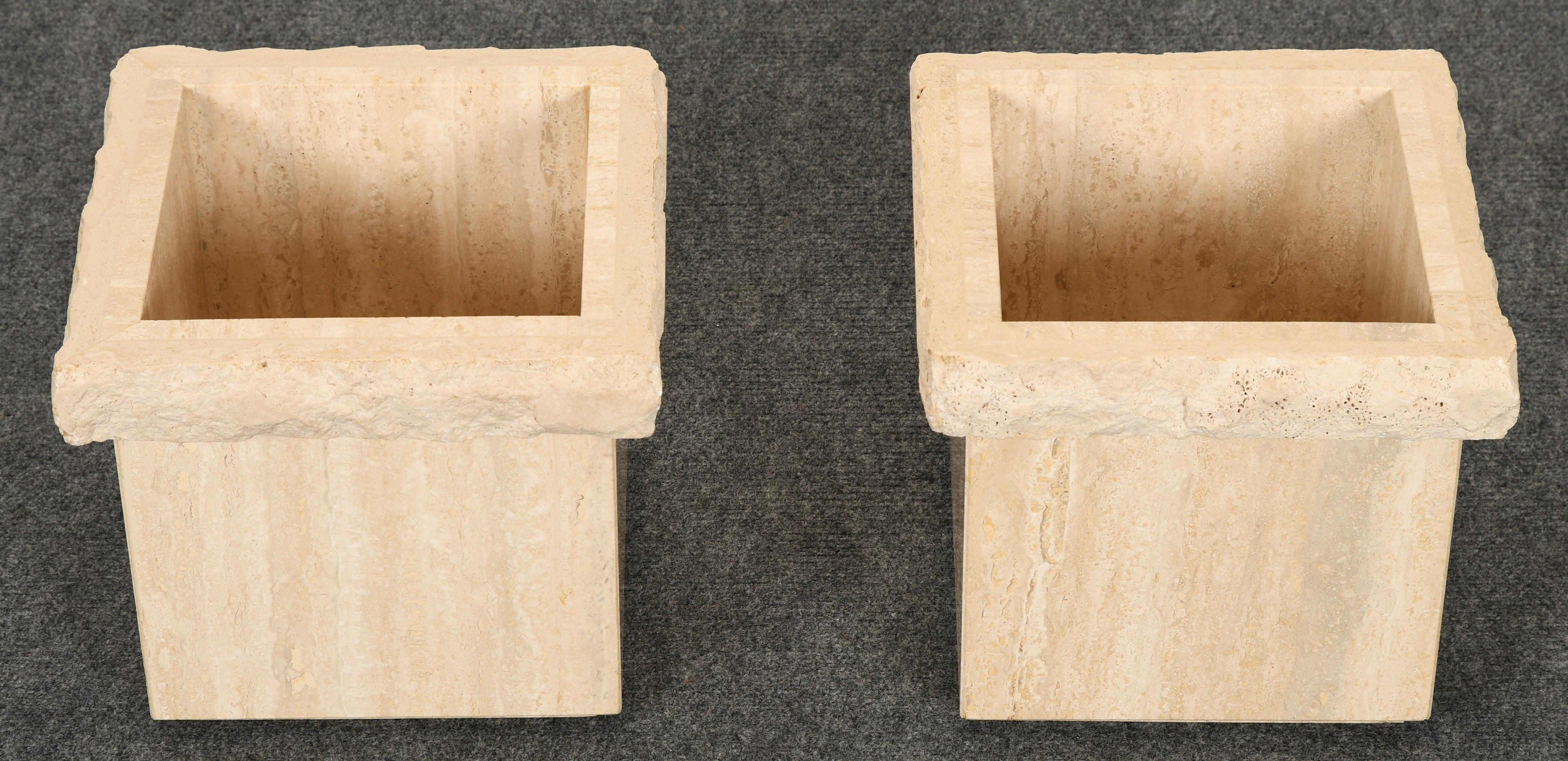 A unique pair of Travertine Roche Bobois style marble planters. These planters have a rough-hewn top edge with a polished Travertine base.

Dimensions: 11.5