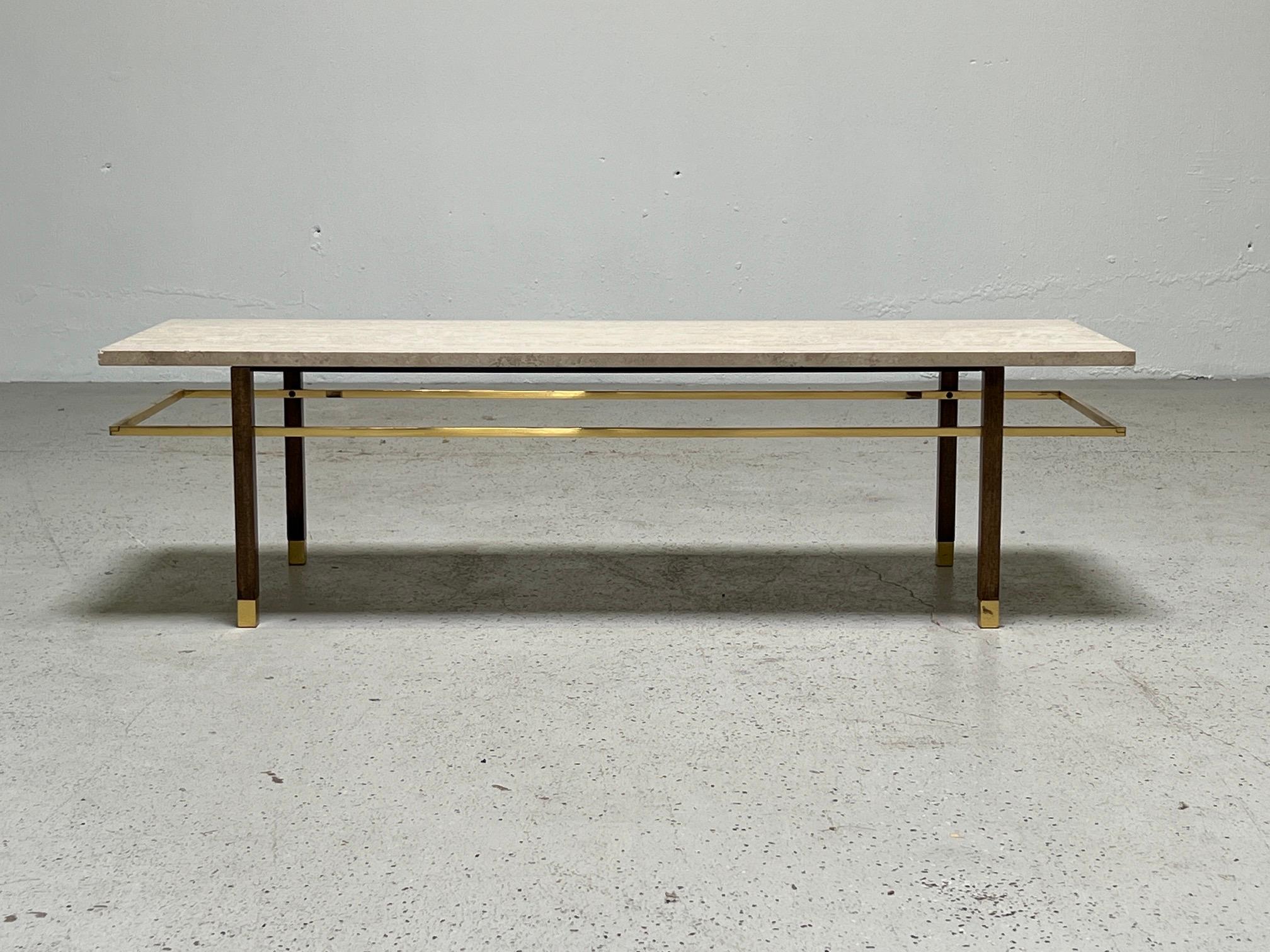 A matching pair of travertine top tables with mahogany bases and brass stretchers / feet. Designed by Harvey Probber.