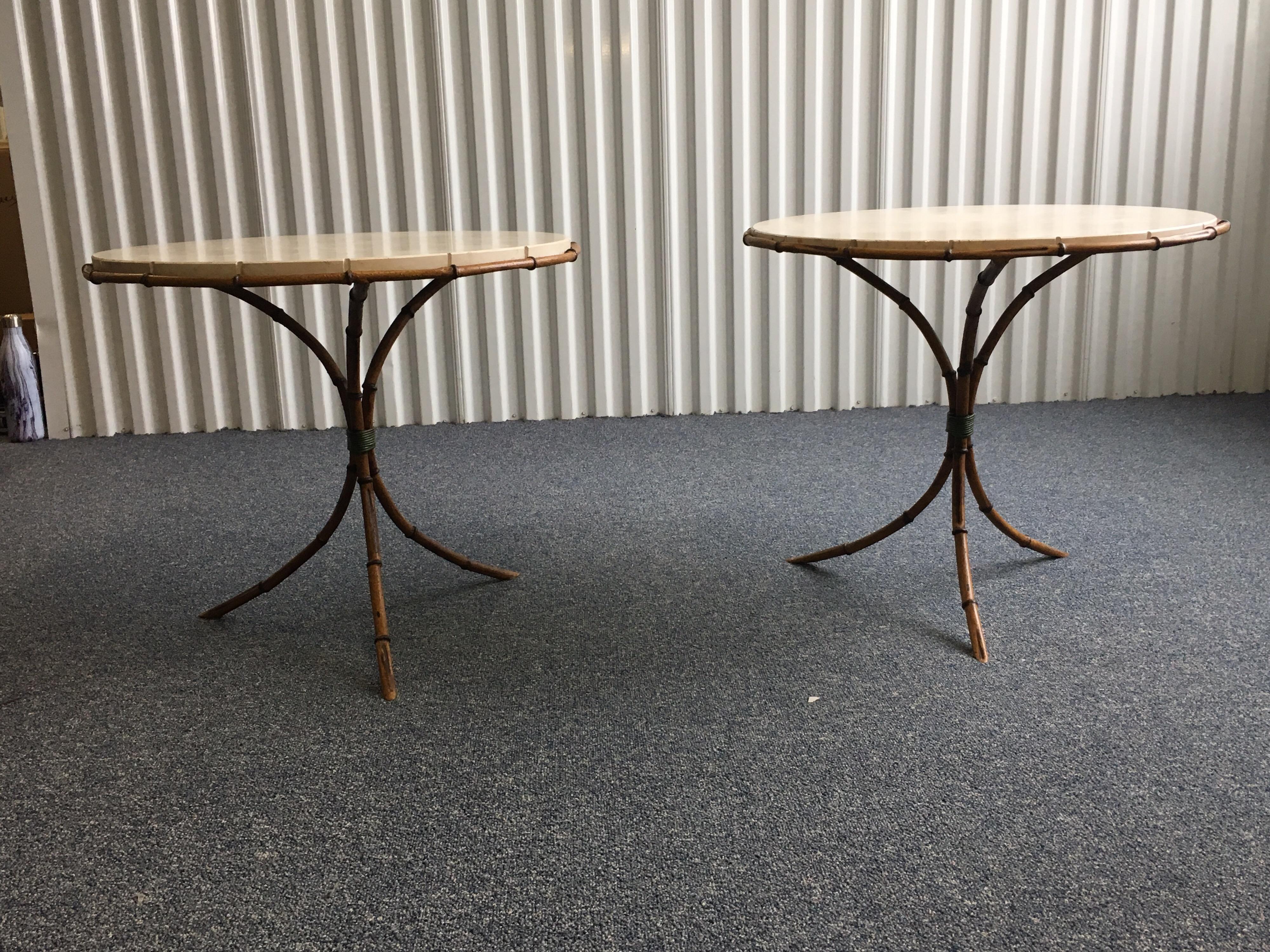 Pair of travertine top bamboo tripod base side tables. Round travertine tops drop into base. Lovely reeding detail in travertine top at each bamboo notch. Bamboo Tripod bases. Minor chip to one travertine top. Great condition otherwise. Great