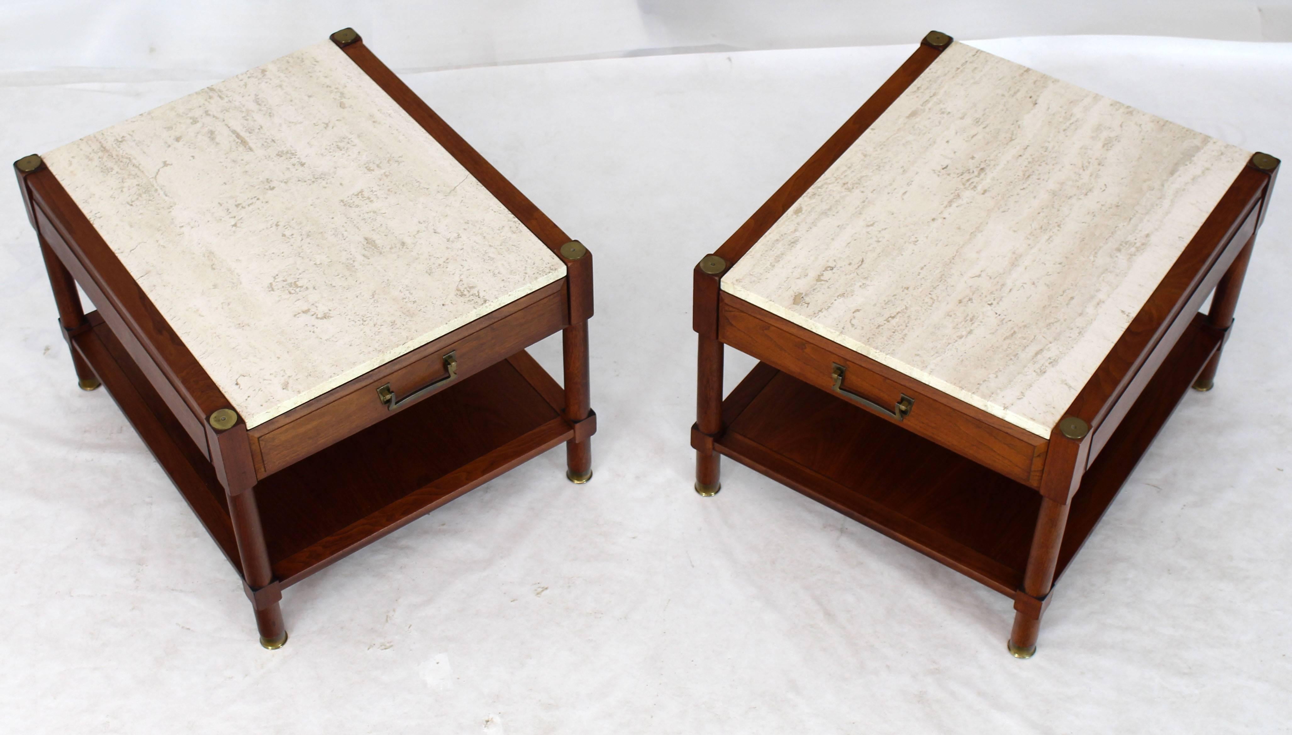 Pair of Mid-Century Modern travertine tops walnut side tables with brass feet and caps.