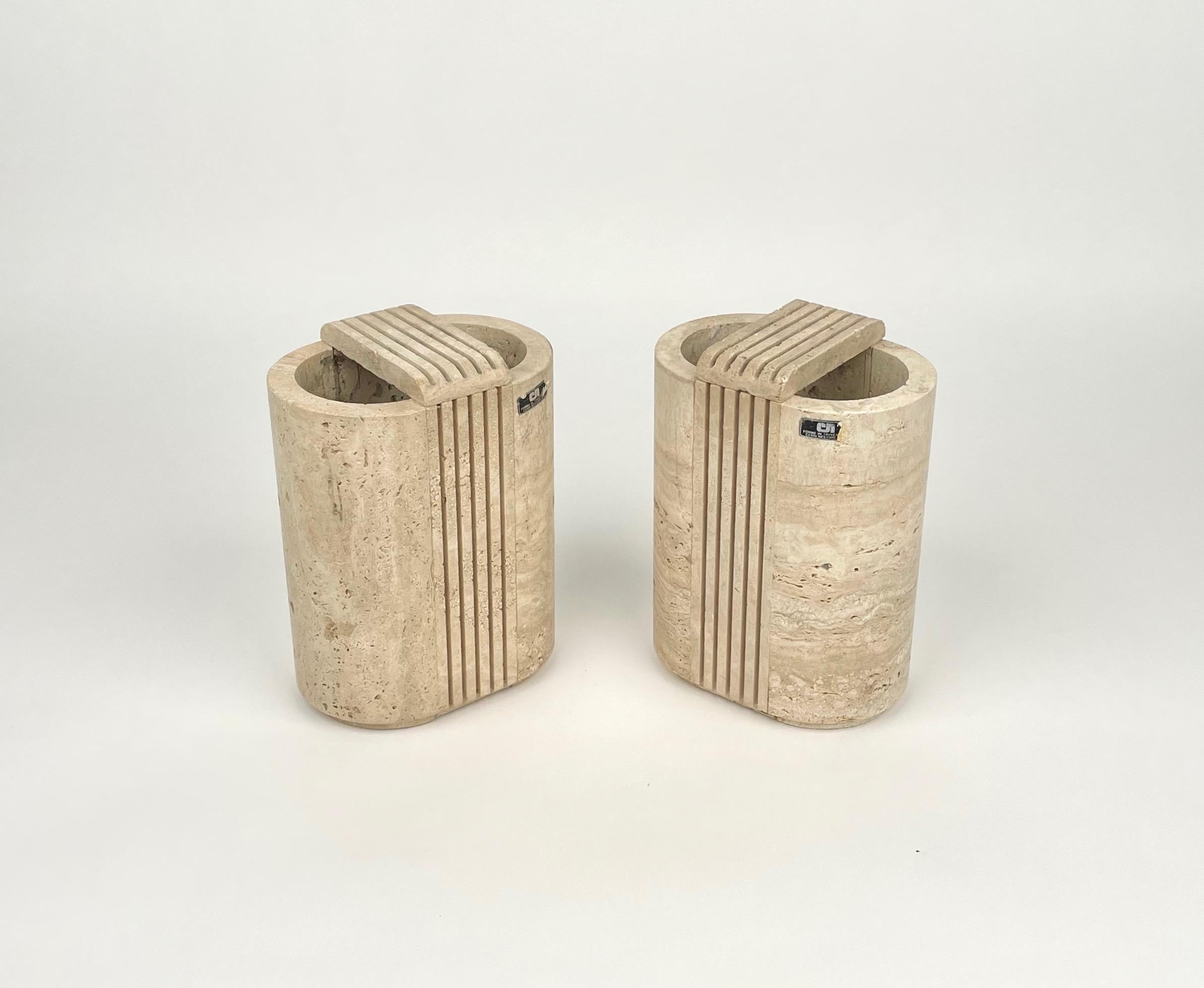 Pair of travertine marble vases by the Italian designer Cerri Nestore. Made in Italy in the 1970s. 

The original labels are still attached on the vases, as show in the pictures.
