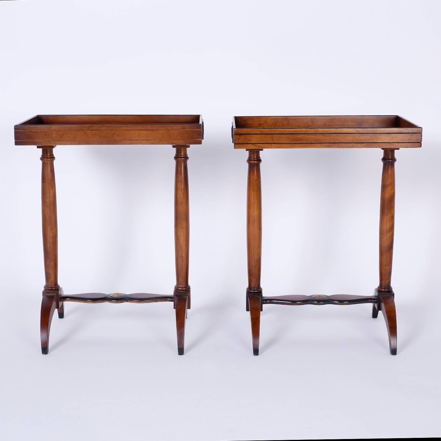 Handsome pair of limited edition vintage end tables featuring tray
shaped tops supported by two turned posts on a base with saber legs
joined by a scalloped stretcher with ebonized trim and centre
medallion. Signed Beacon Hill on a paper label.