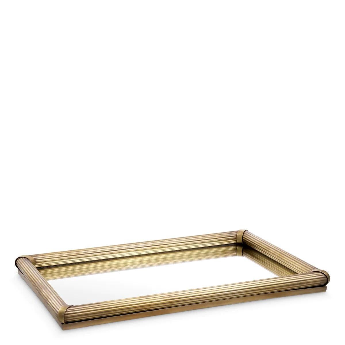 Discover the timeless charm of these trays. 
This rectangular serving accessory, with its handcrafted ribbed frame and vintage brass finish, is a testament to meticulous attention to detail and superior craftsmanship. Whether used as a centrepiece