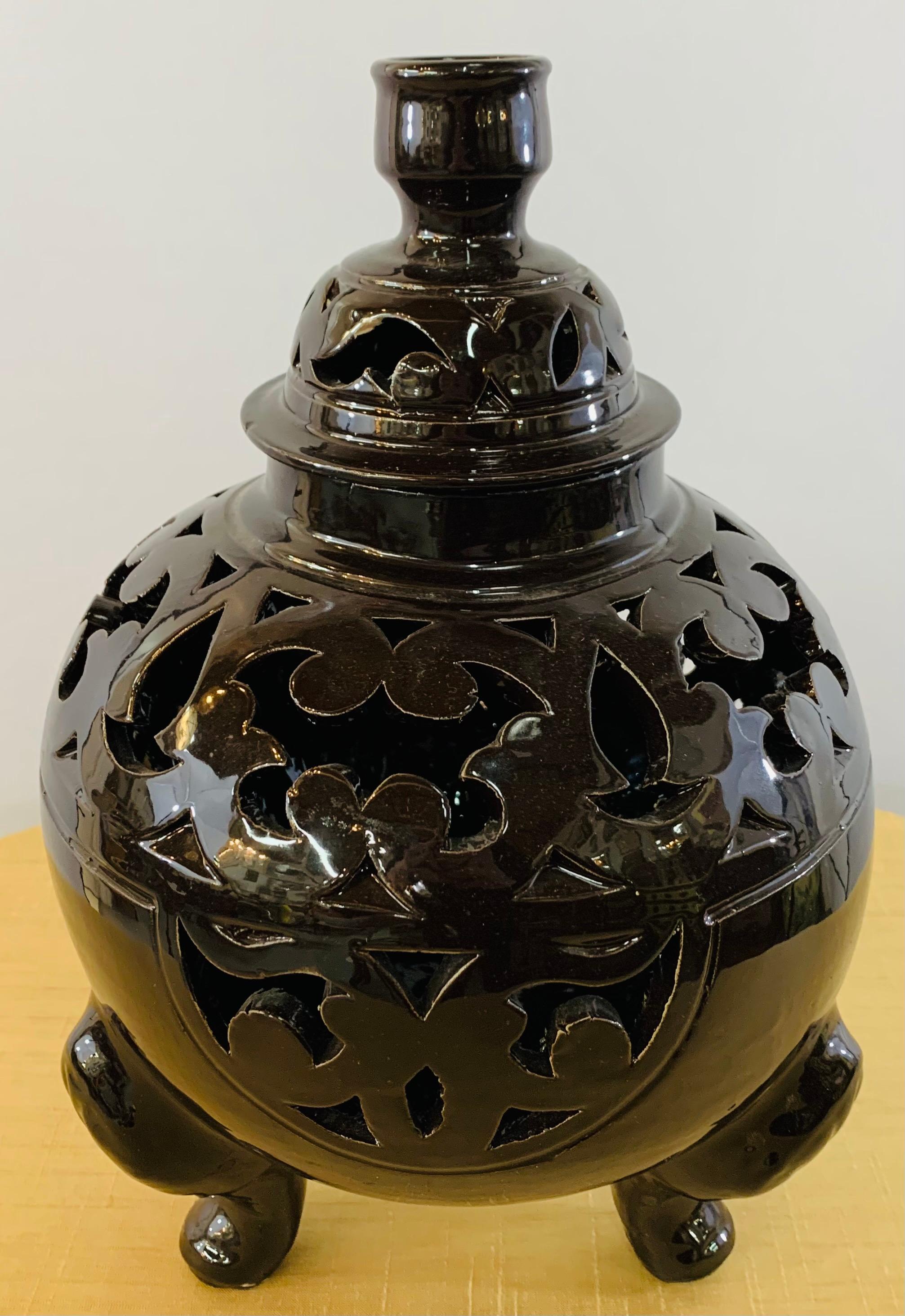 These stylish and one of a kind tri-pod leg fire engine red and ebonized black lidded urns are handmade and are an exquisite piece of pottery to decorate any space and bring style to your living space. These urns can be wired and used as table
