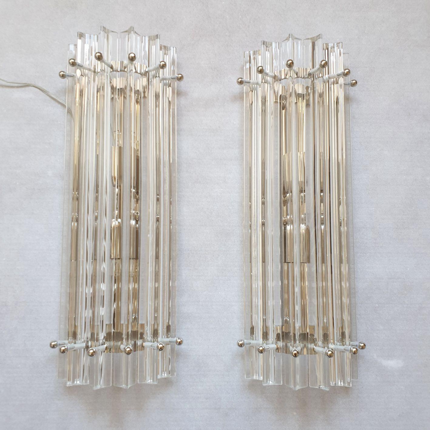 Pair of Triedri Murano glass wall sconces, or flush-mounts, Mid-Century Modern by Venini, Italy 1980s.
Set of four pairs, or eight sconces available.
Sold and priced by pair.
The vintage sconces have chrome mounts.
Two-light each, rewired for the
