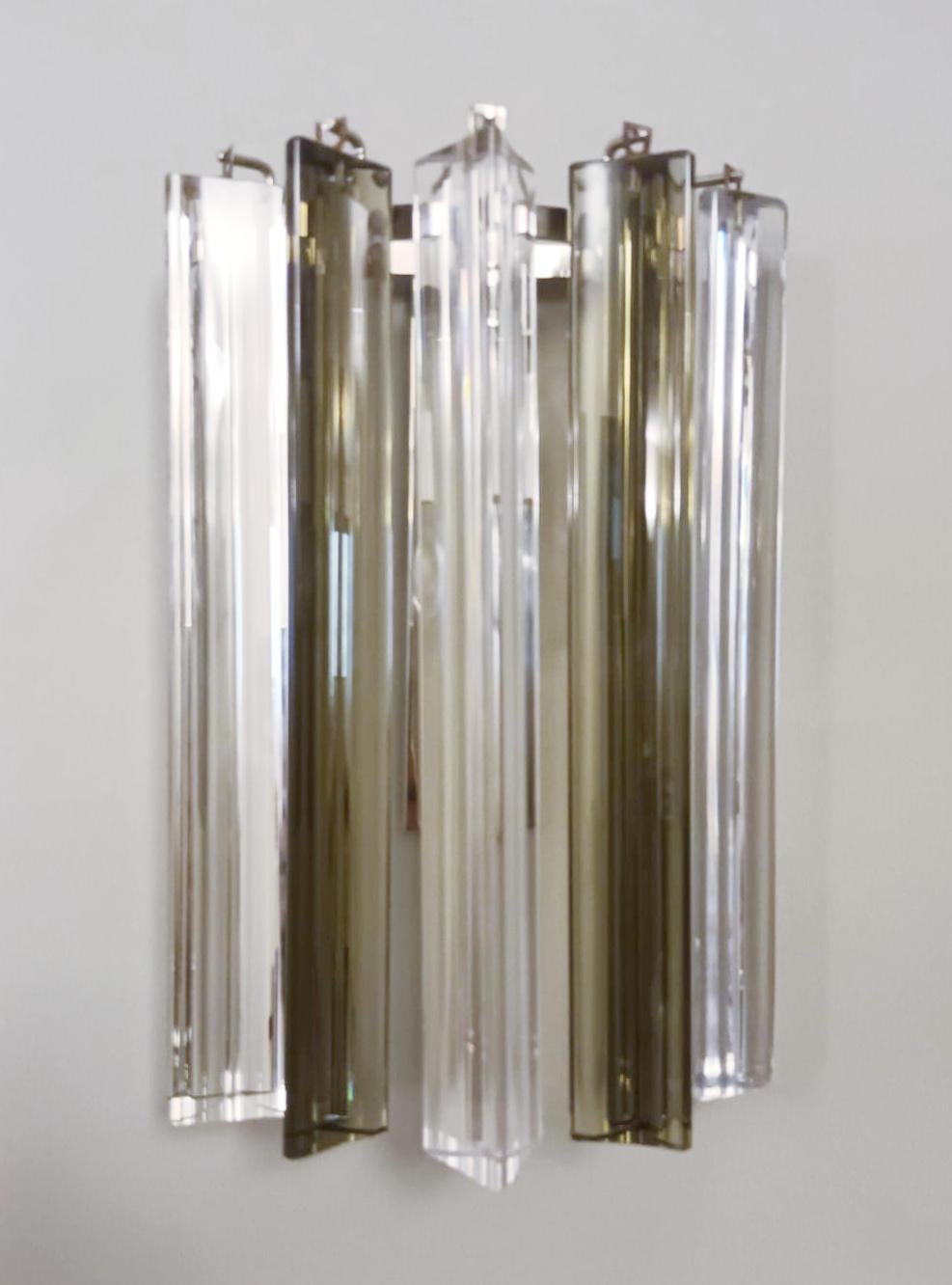 Pair of Italian wall lights with clear and smoky Triedri glass crystals mounted on chrome brackets / Made by Venini, circa 1960s
Measures: Height 12 inches, width 8 inches, depth 4 inches
1 light / E12 or E14 type / max 40W
1 pair available in