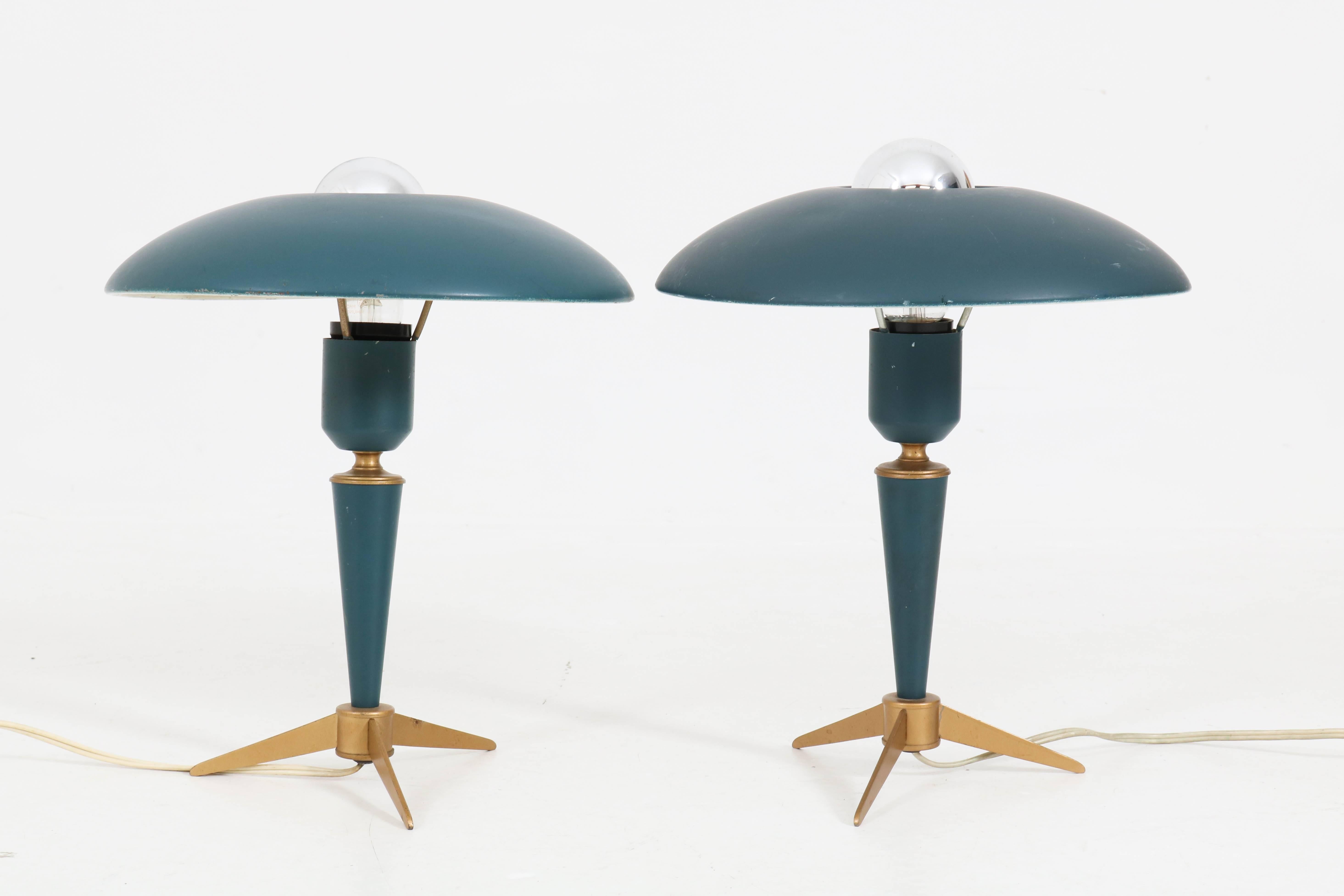 Funky pair of desk lamps by Louis Kalff for Philips.
Striking Dutch design from the fifties.
Tripod brass base with lacquered blue/green metal shade.
In good original condition with minor wear consistent with age and use,
preserving a beautiful