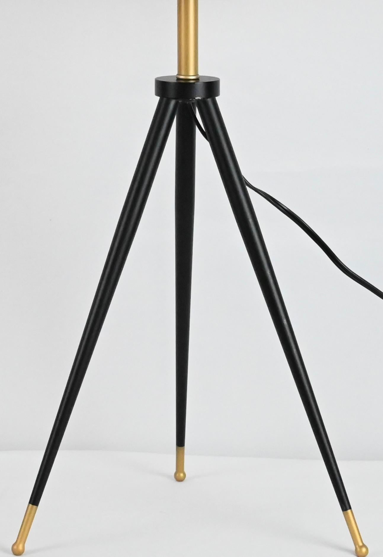 Pair of tripod lamps in a contemporary design.  Very sleek and stylish. 
The base of these lamps are made of wood that have been painted black and the shades are made of metal painted gold. 
 
Each measures:  28