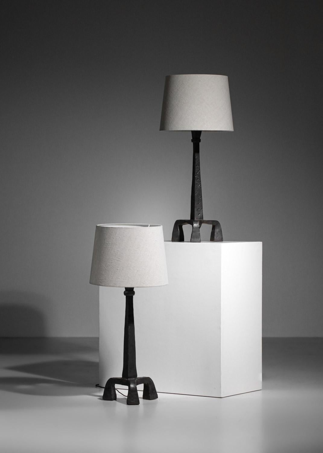 Pair of large Brutalist table lamps from the 50's in the style of Diego Giacometti's work. Solid wrought iron tripod base, with a pure and graphic design.  Lampshade of presentation, possibility to realize them on estimate. Recommended LED bulb type