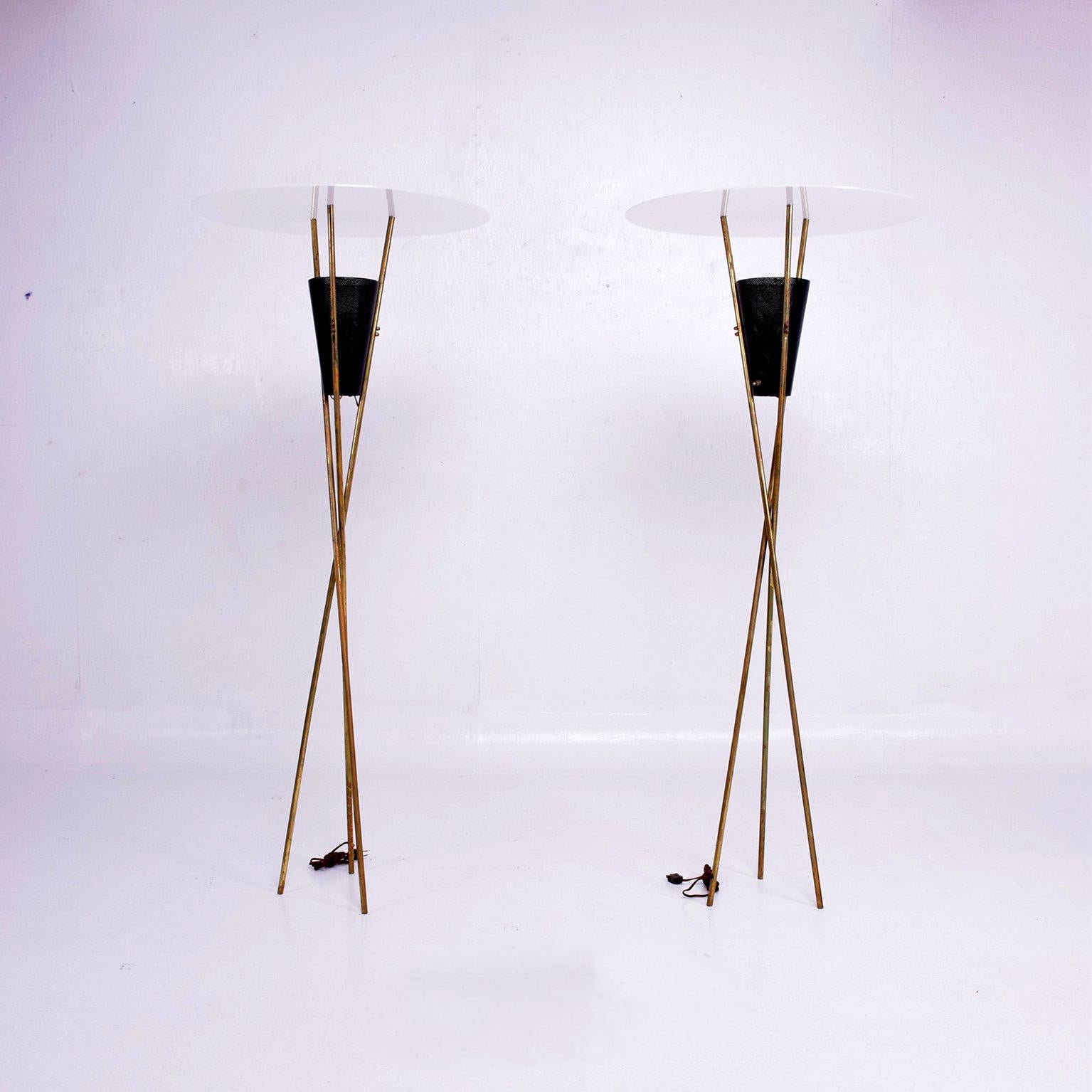 For your consideration a pair of Mid-Century Modern floor lamps or torchierers.

Tripod base in brass with perforated metal shade.
The white diffuser in a new white acrylic in white translucent color.



Dimensions:
55