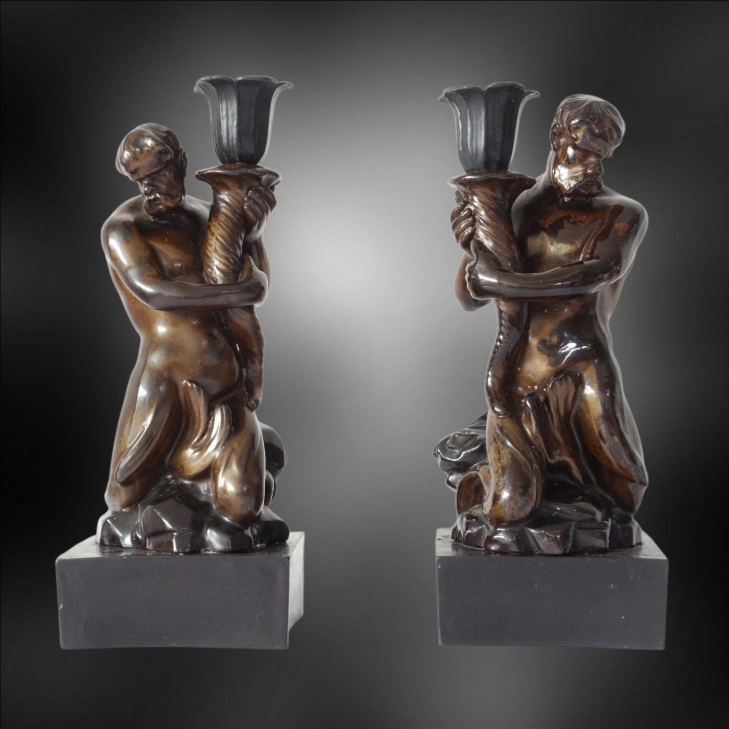 An exceptionally rare pair of Triton candlesticks, in black basalt with gold lustre. The design is copied from Wedgwood, who took it from Sir William Chambers' study of Bernini's Triton Fountain, in the Piazza Barbarini.

An unscrupulous dealer (not
