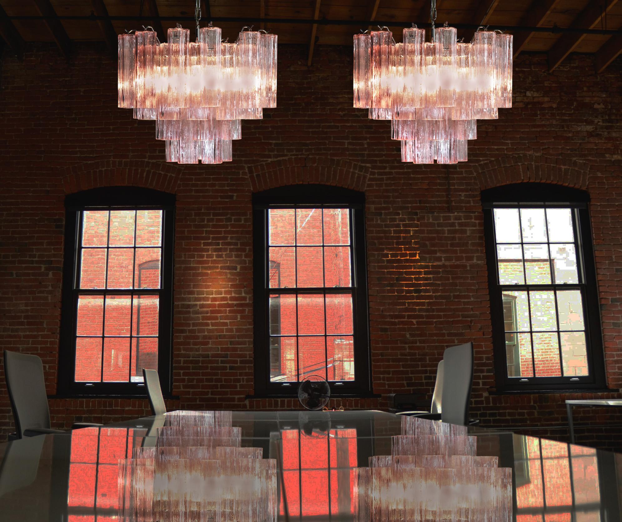 Pair Italian vintage chandeliers in Murano glass and nickel-plated metal structure. The armor polished nickel supports 36 large pink glass tubes in a star shape.
Period: Late 20th century
Dimensions: 45.30 inches (115 cm) height with chain, 19.70