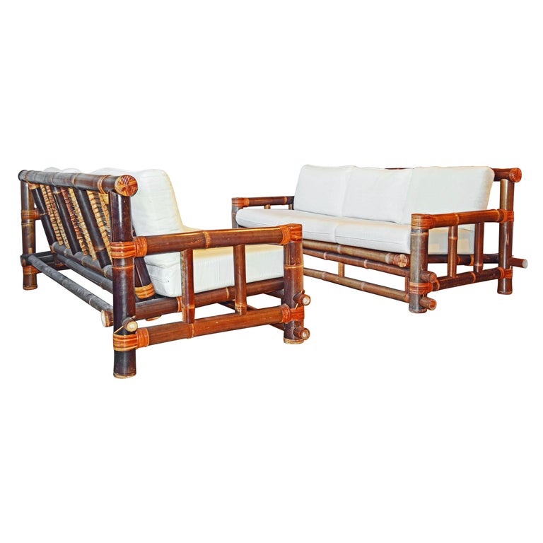 Pair of Tropical Traditionally Joined Bamboo Pole Sofas with Off White Cushions For Sale