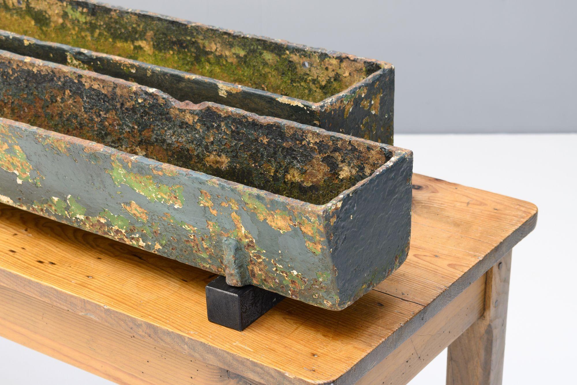 Pair of cast iron planters / troughs in aged paint finish. Circa 1900.

H 13cm x W 184cm x D 17cm