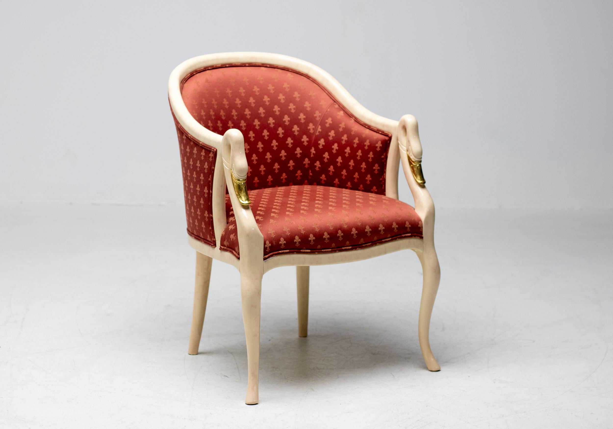 Beautiful pair of artisan crafted chairs. Marble paint and gold leaf was the choice for the organic shaped solid wood framework. A poppy red damask fabric was applied by the master upholsterers of Trüggelman. This is an excellent choice either as an