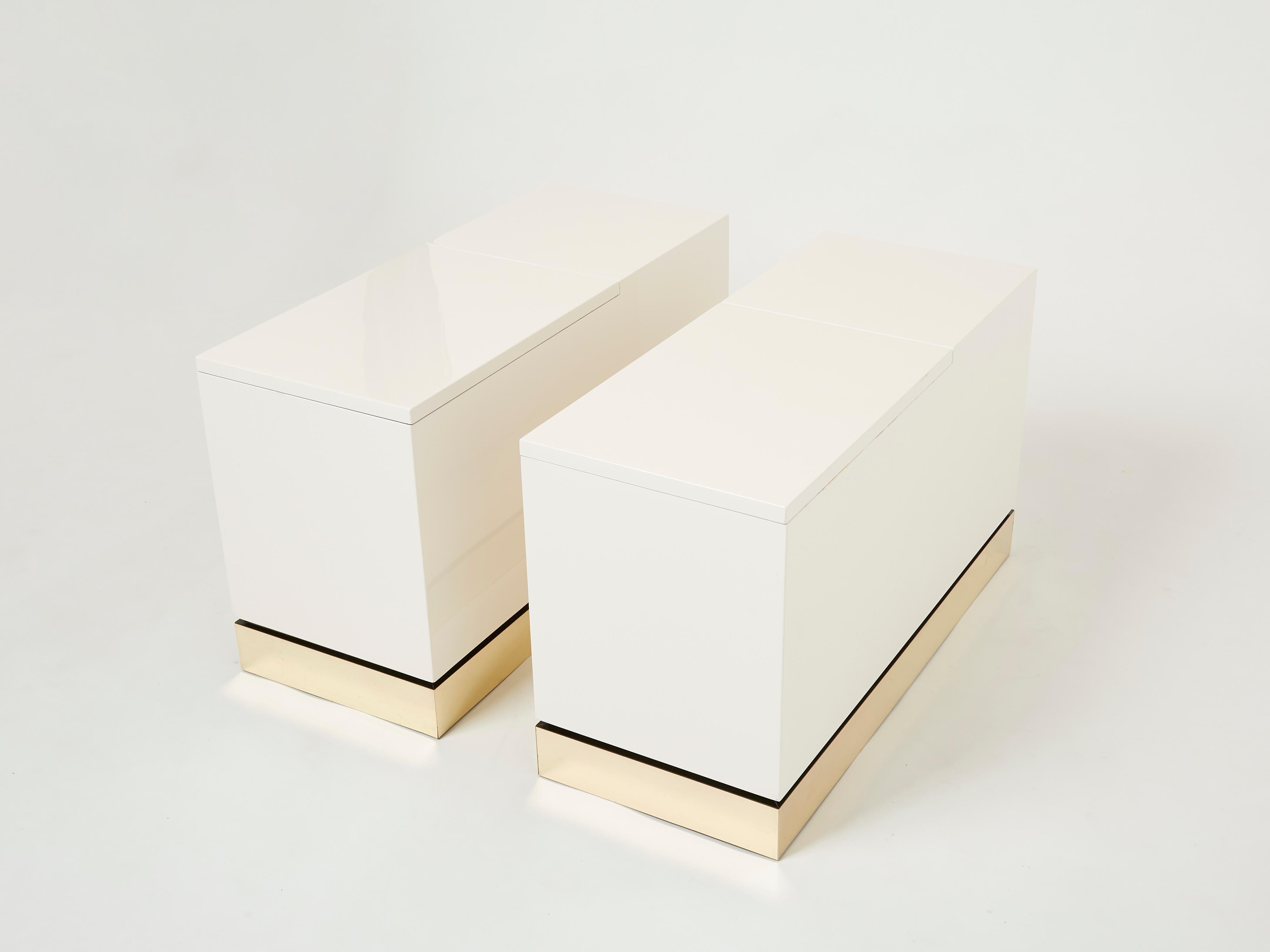 A rare pair of vintage Jean-Claude Mahey for Romeo Paris trunk end tables made in France in the 1970s. Crisp white lacquer, paired with a bright brass base feels crisp and luxe. Each table trunk features one large door with plenty of storage for