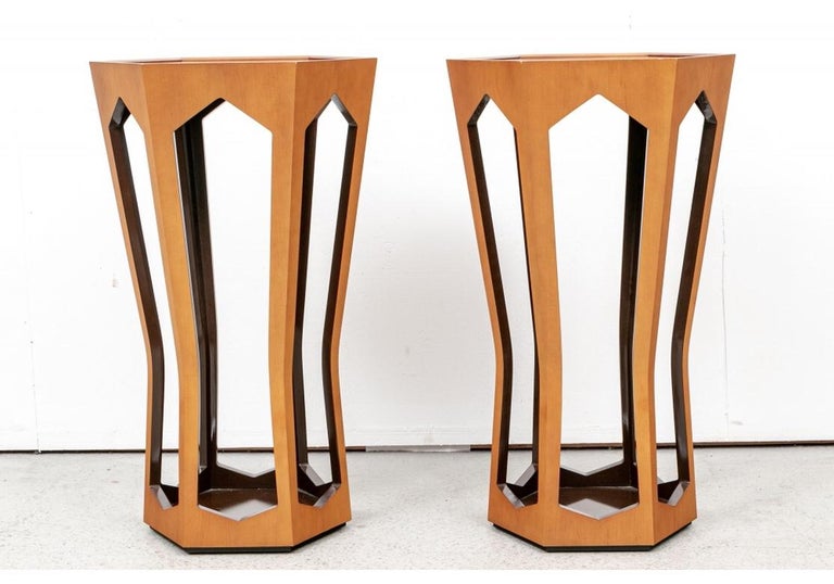 Classic late 20th Century Modernist hexagonal stands from Donghia in blond wood with carved top moldings and openwork angular shaped supports tapering to the bases. The insides in a darker lacquer finish. Mounted on smaller hexagonal deep bases.