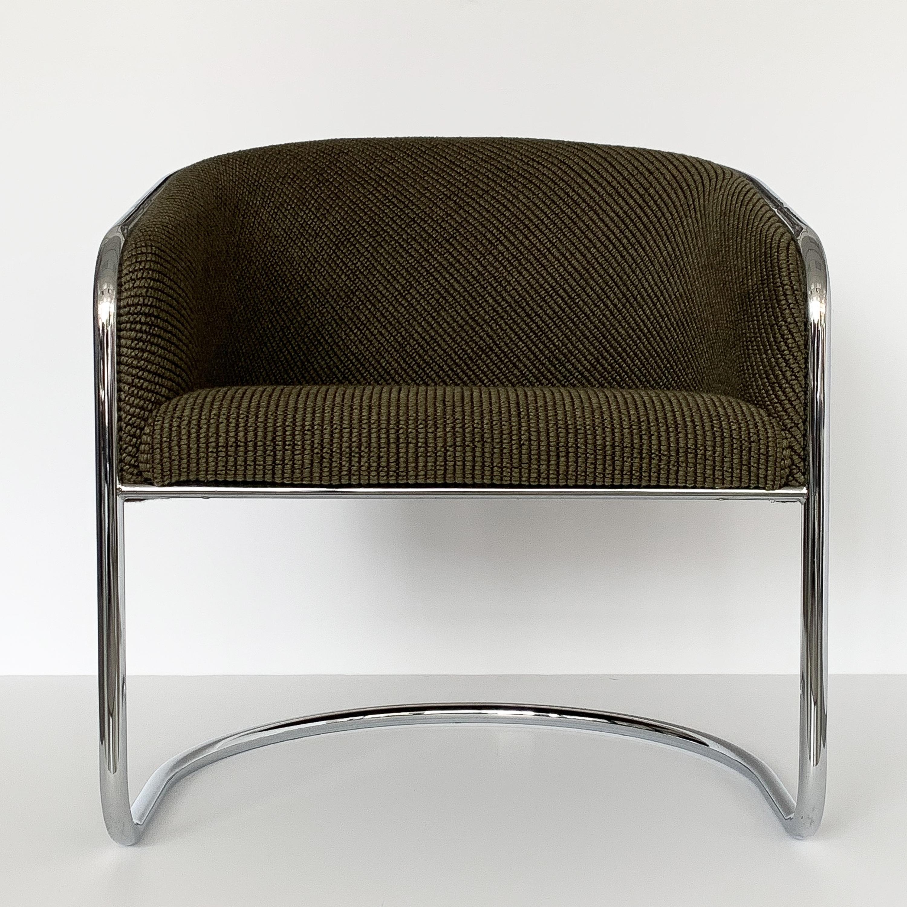 Pair of tub / club cantilever dining or lounge chairs by Joan Burgasser / Anton Lorenz for Thonet, circa 1970s. Chrome-plated tubular steel frames. Original moss / army green textured upholstery is in excellent condition. The ribbed woven fabric is