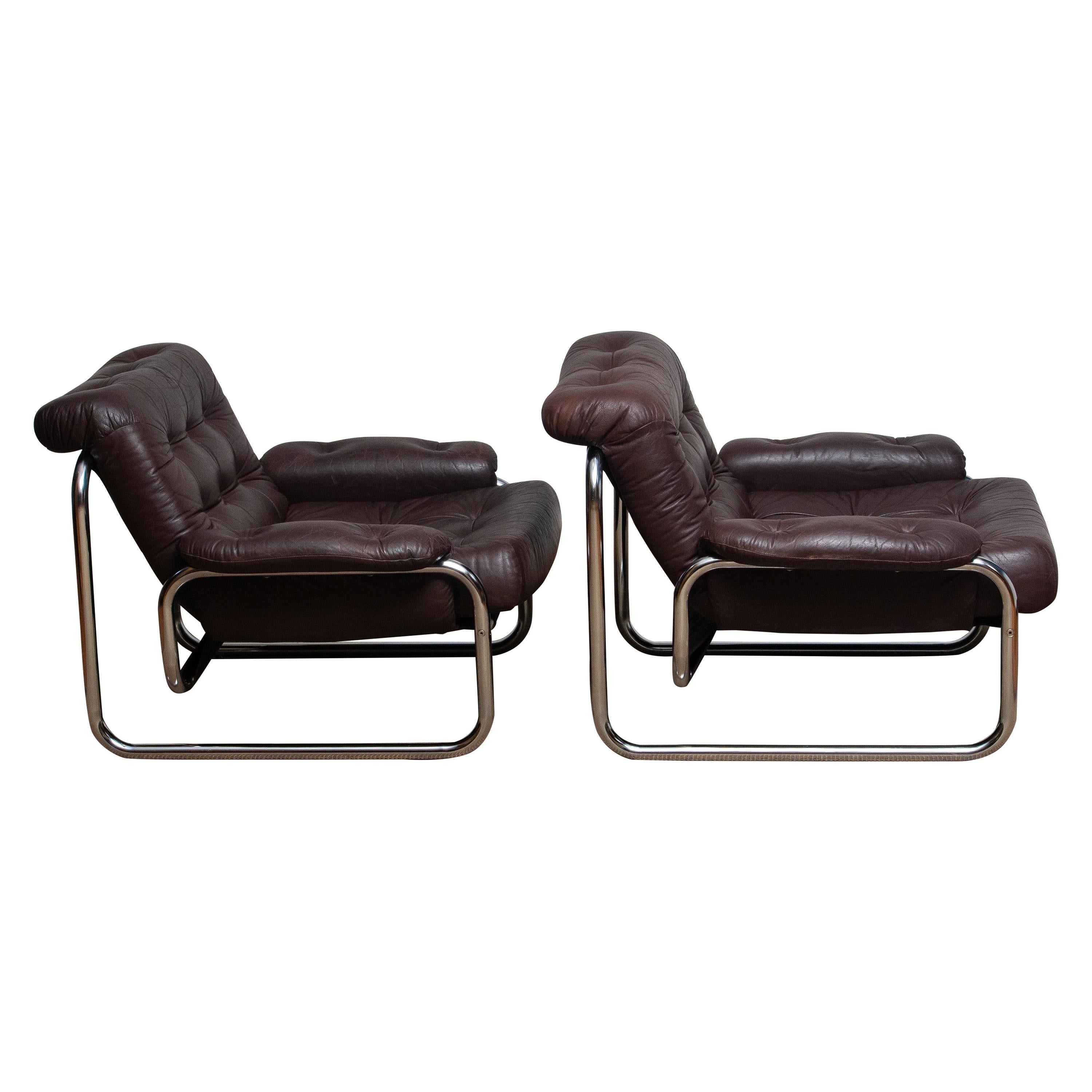 Pair of lounge / easy chairs model 'Troligen' designed by Johan Bertil Häggström for Sved Form, Sweden
These chairs are made of a tubular metal chromed frame with brown leather cushions and armrests.
They are in a wonderful condition.
Produced in
