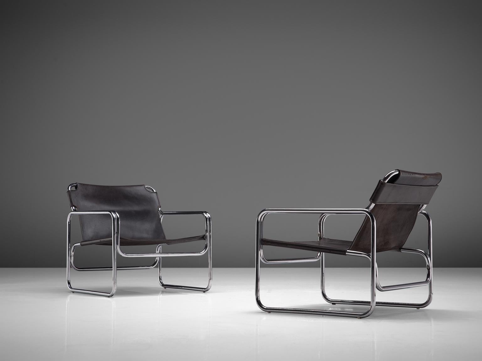 Pair of armchairs, metal and leather, the Netherlands, 1960s.

These tubular chairs are a great example of the radical Bauhaus aesthetic. Functional and light thanks to the combination of strong, lasting materials; bended tubular steel with dark
