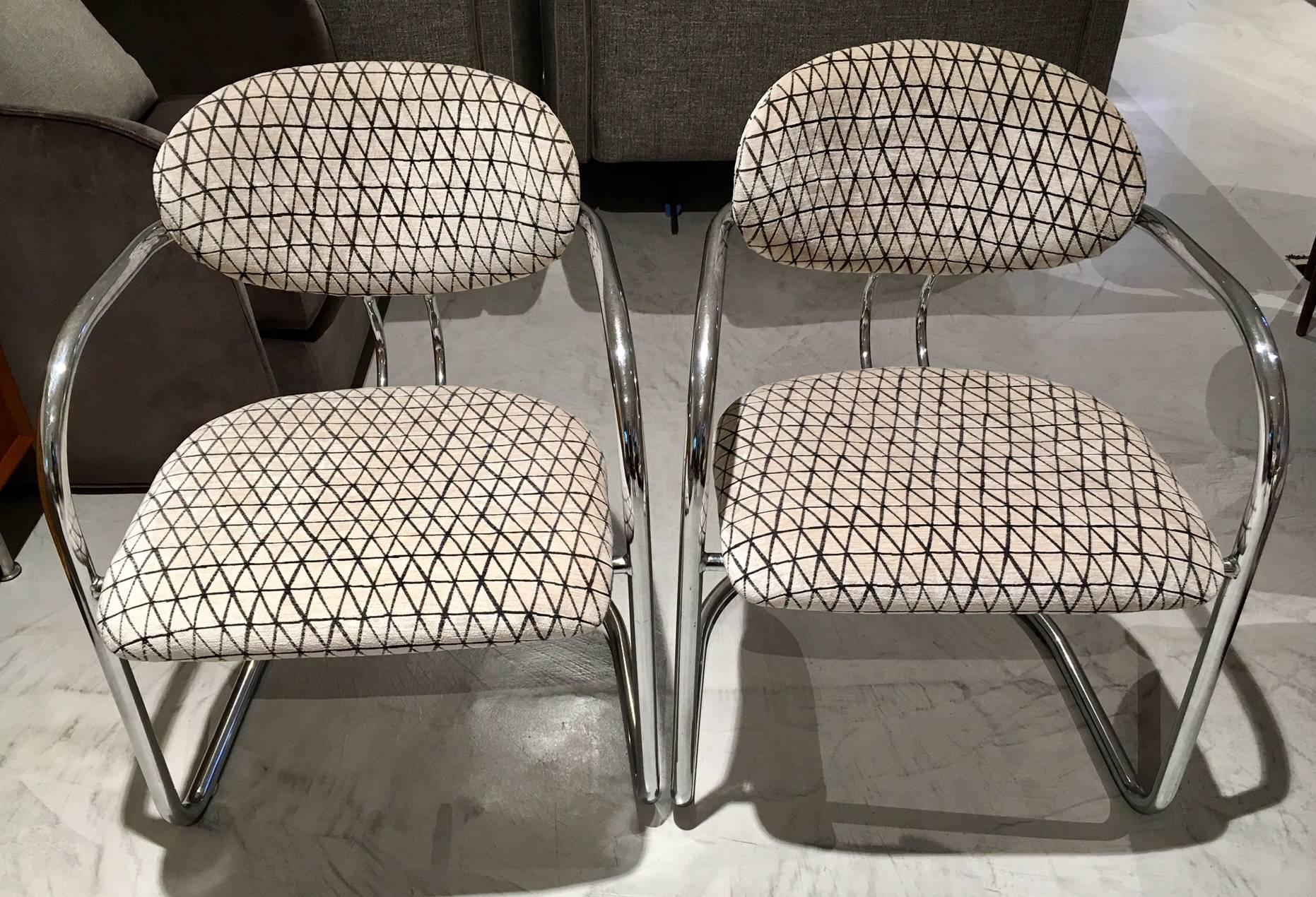 Pair of tubular steel chairs, produced in Italy. Back and seat newly upholstered in geometrical textured velvet. Minor signs of wear on the steel frame.