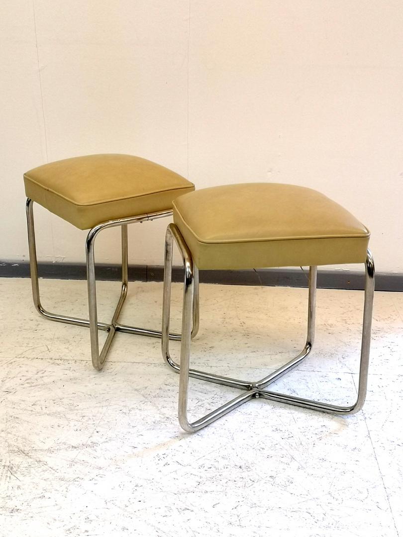 These items were made in the 1930s, truly Bauhaus style, the two ottomans feature nickel-plated legs and a leather upholstery. They're in great condition.