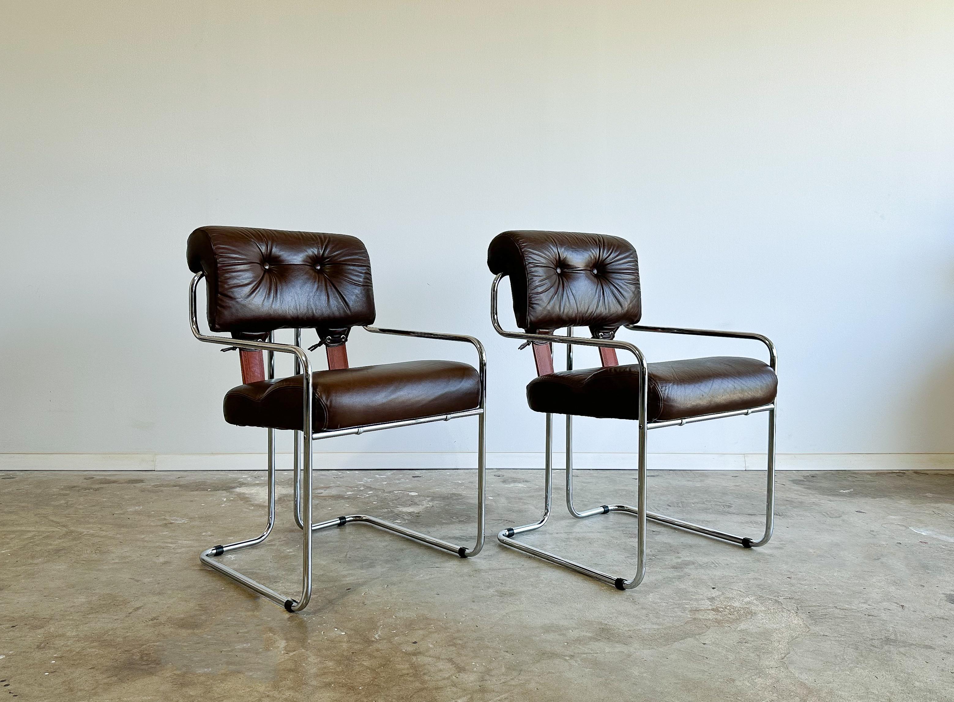 Offered is a beautiful pair of Tucroma chairs designed by Guido Faleschini for I4Mariani, Italy. 

These have a wonderful combination of materials: rich chocolate brown leather and polished chrome tubular frames, accented by embossed natural saddle