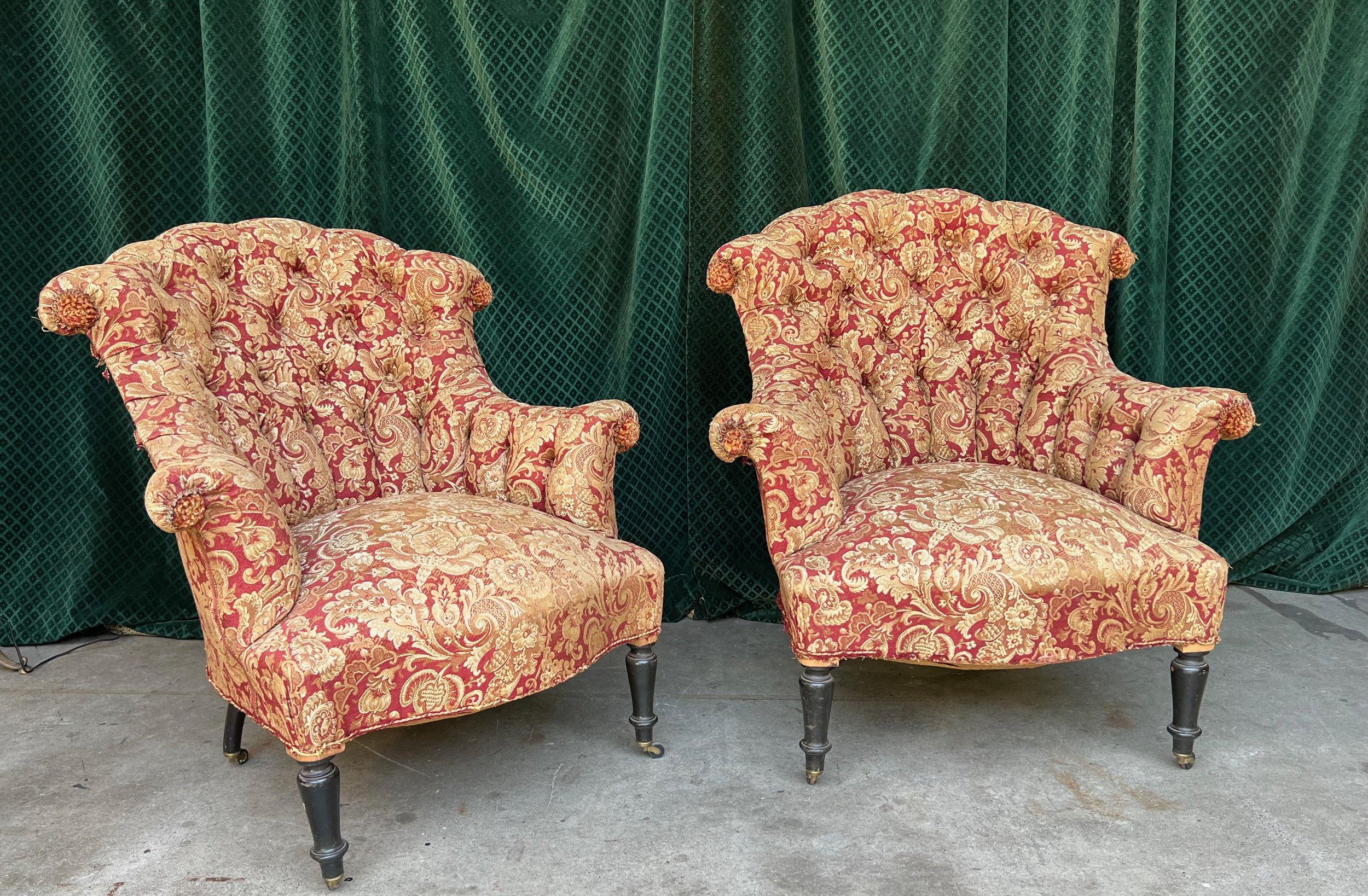 A stunning pair of 19th century French tufted and scrolled armchairs, reflecting the distinguished Napoleon III style. These sophisticated and elegant chairs have the potential to elevate any living space with their presence. With their elaborate