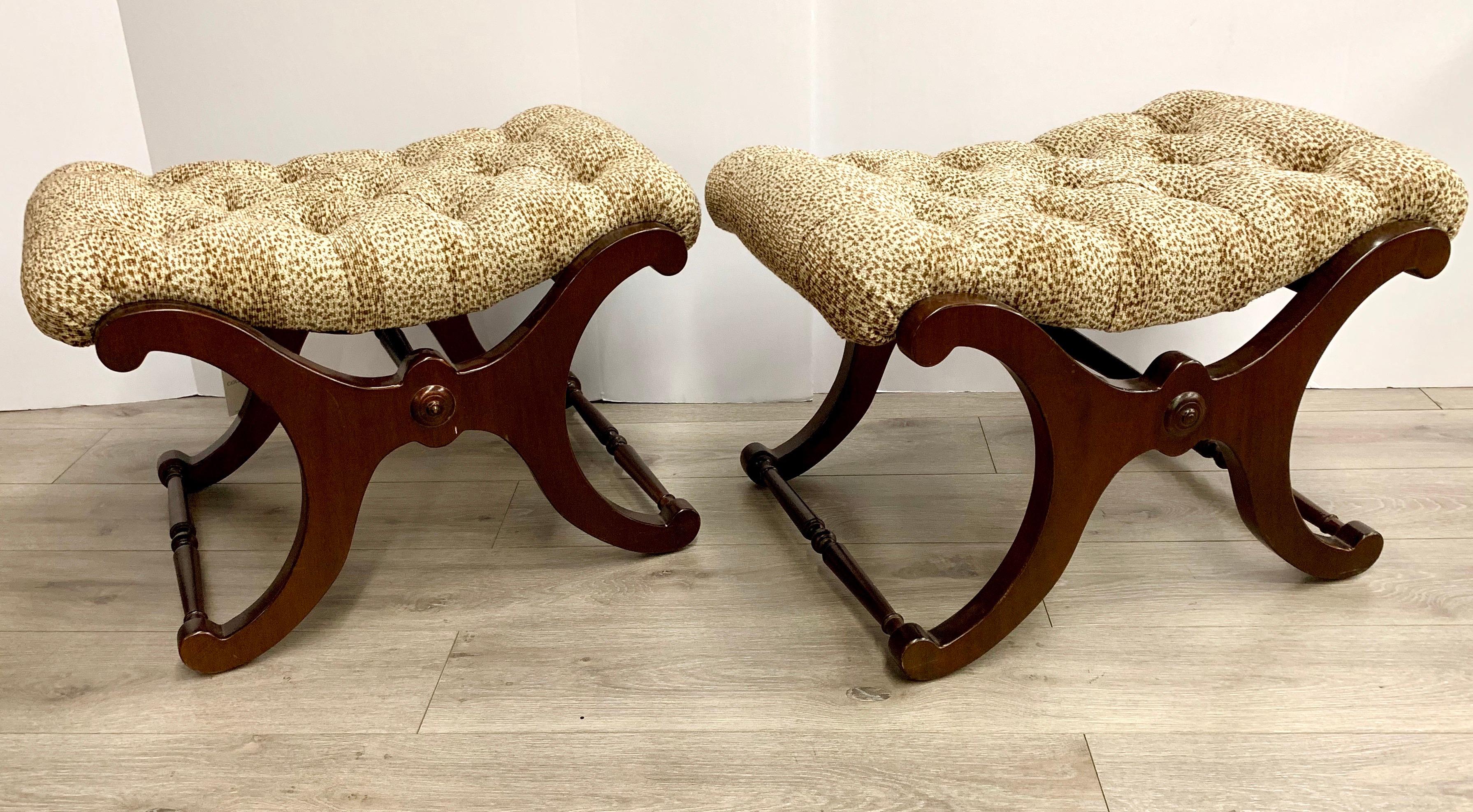 Elegant pair of tufted leopard print X base ottomans that can also function as benches.