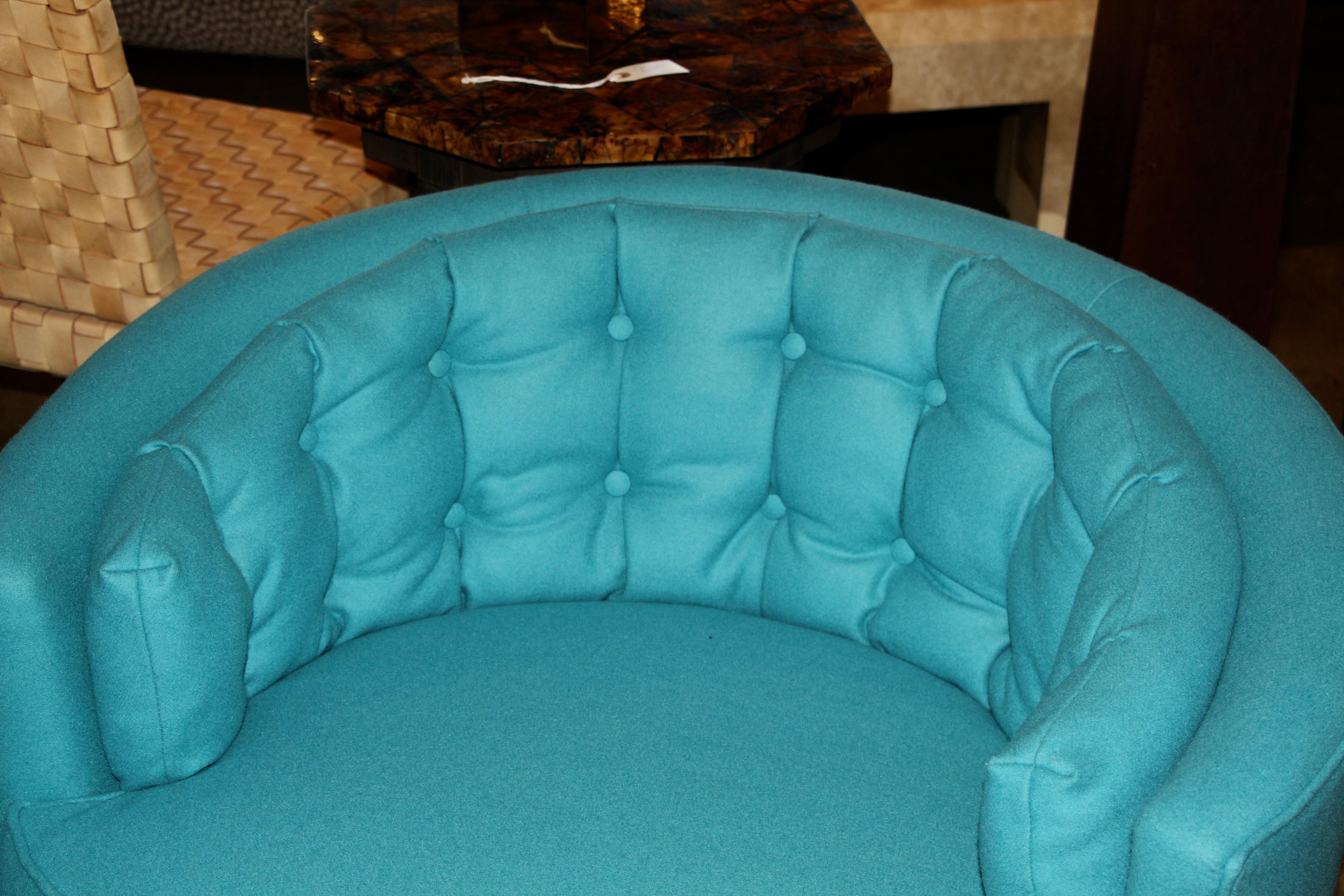 A nice pair of tufted button detail swivel chairs on metal bases. These chairs have been re-upholstered in a turquoise wool fabric and are quite comfortable. There are minor marks to the metal bases.