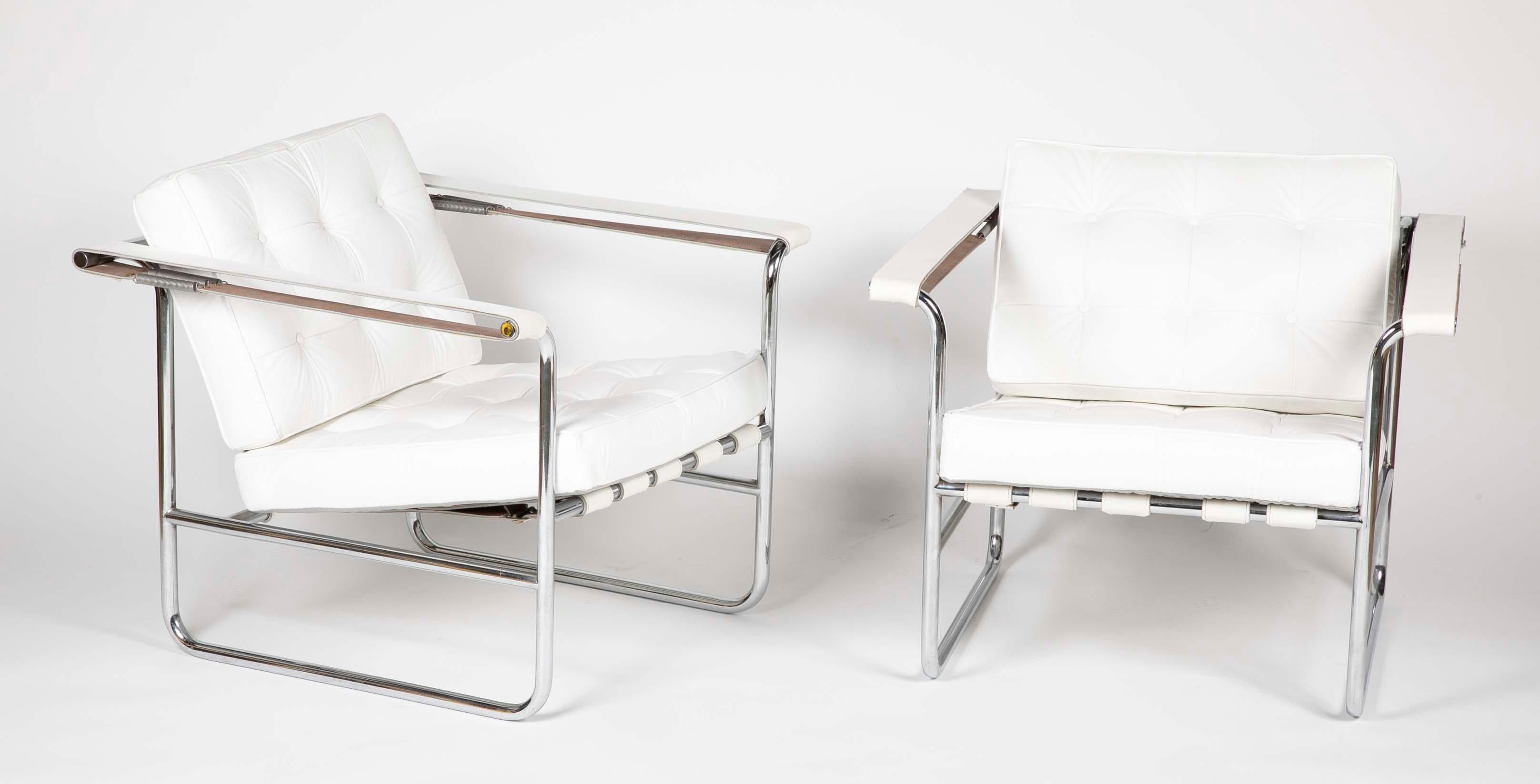 A pair of chromed tubular metal and tufted white leather lounge chairs produced by Stendig, Switzerland.