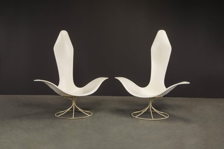 This incredible design is a pair of Model 120 LF 'Tulip' lounge armchairs by Erwine and Estelle Laverne for Laverne International. Ingeniously designed in 1957, this wide span armchair is crafted from molded fiberglass, and enameled steel. 

This