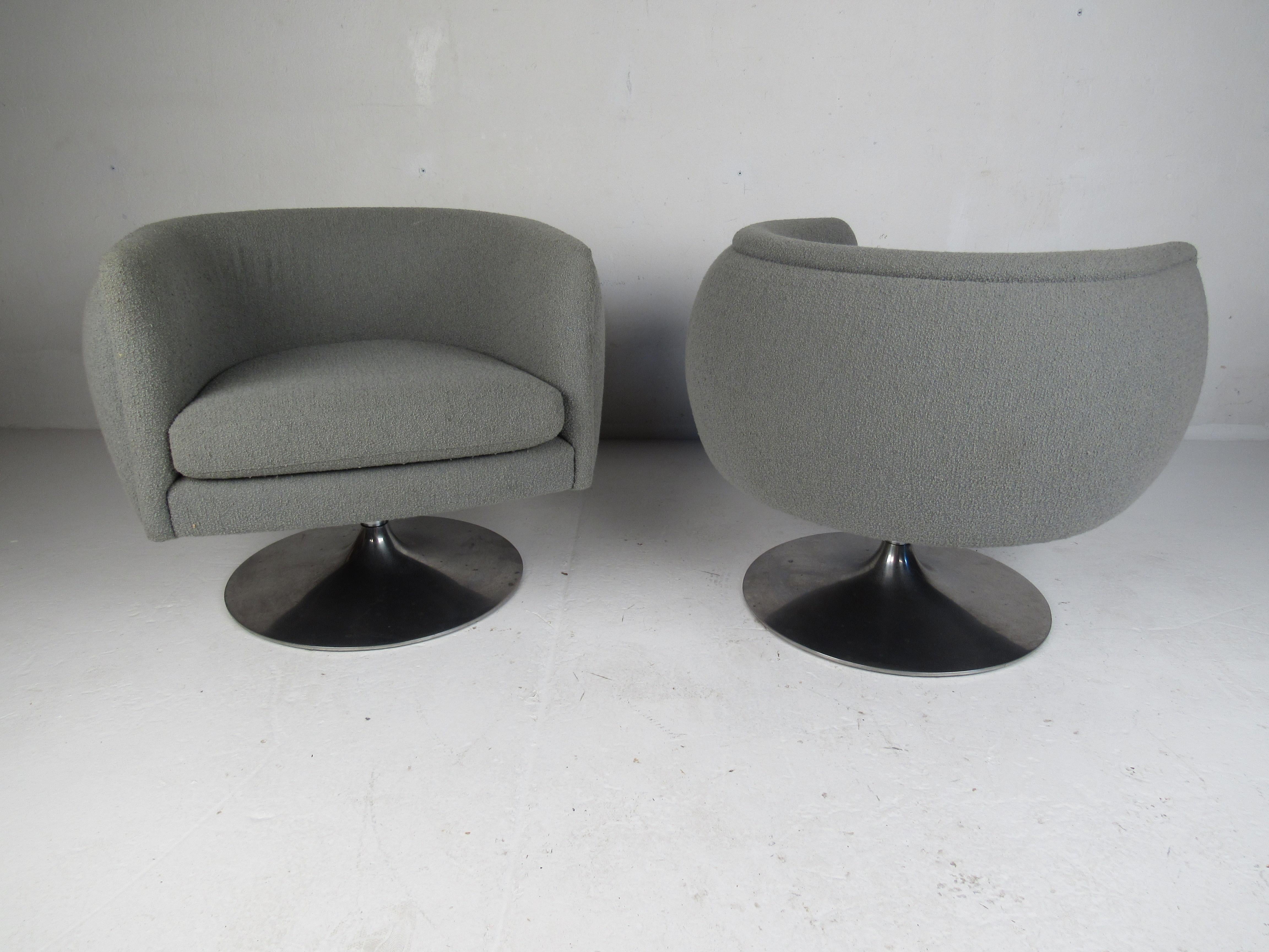 This impressive pair of swivel lounge chairs feature a tulip shape with an aluminum pedestal base and overstuffed seating. The thick removable cushions and 360 degree swivel add convenience without sacrificing style. A sleek and comfortable pair of