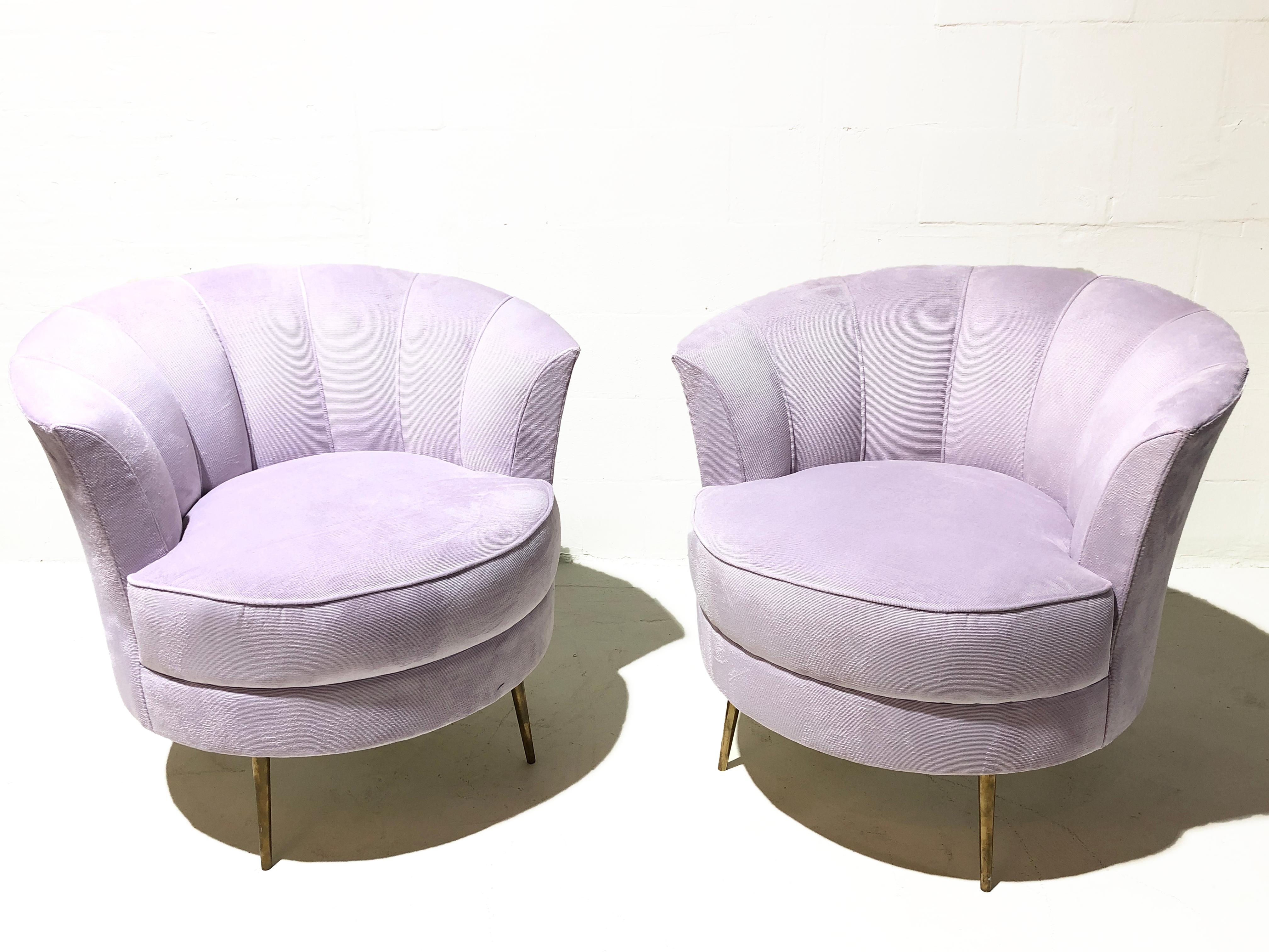 These vintage 1960's club chairs feature transitional Italian styling and solid brass lags. The fabric is a synthetic velvet in a pale violet color.
