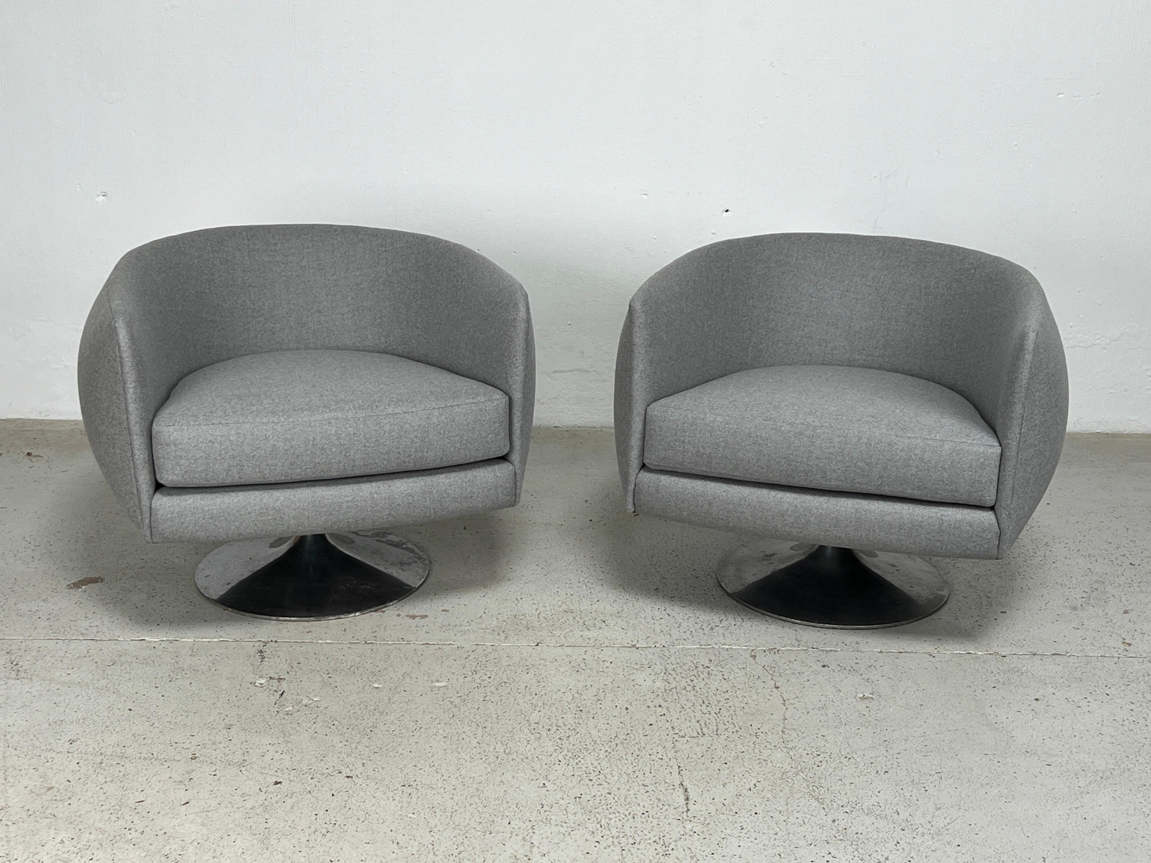 A pair of tulip base swivel chairs designed by Adrian Pearsall for Craft associates. Fully restored and upholstered in a grey wool felt.