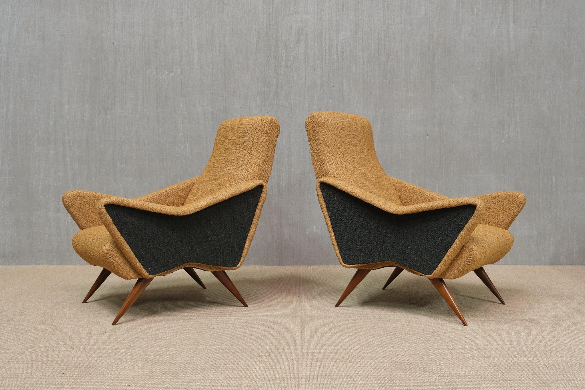 This striking pair of armchairs was designed and produced in the Turin region of Italy in the early 1950s.

The design is distinguished by the geometric, angular lines of the armrests and legs. The bicolor upholstery, in a muted yellow ochre/mustard
