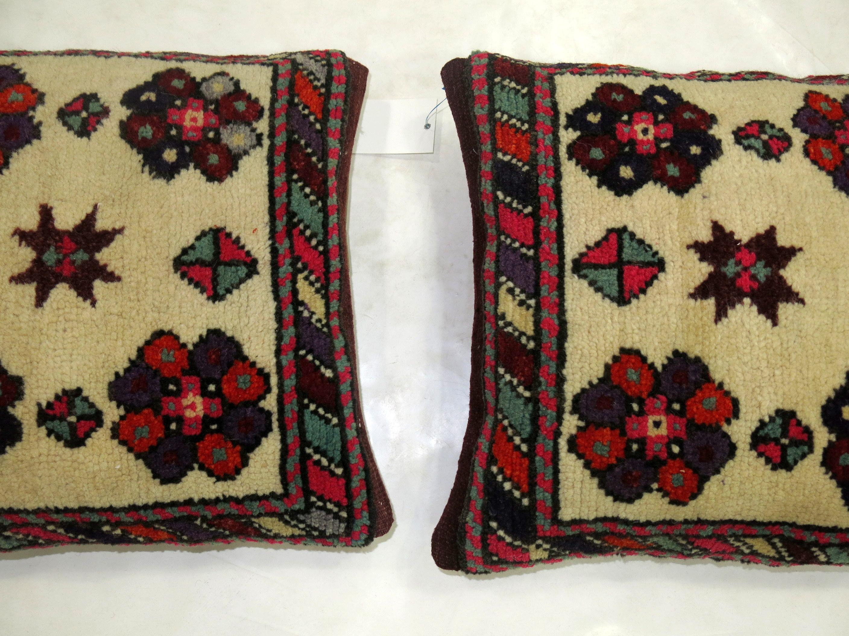 A pair of pillows made from a mid 20th century turkish rug

each measure 18'' x 18'' 