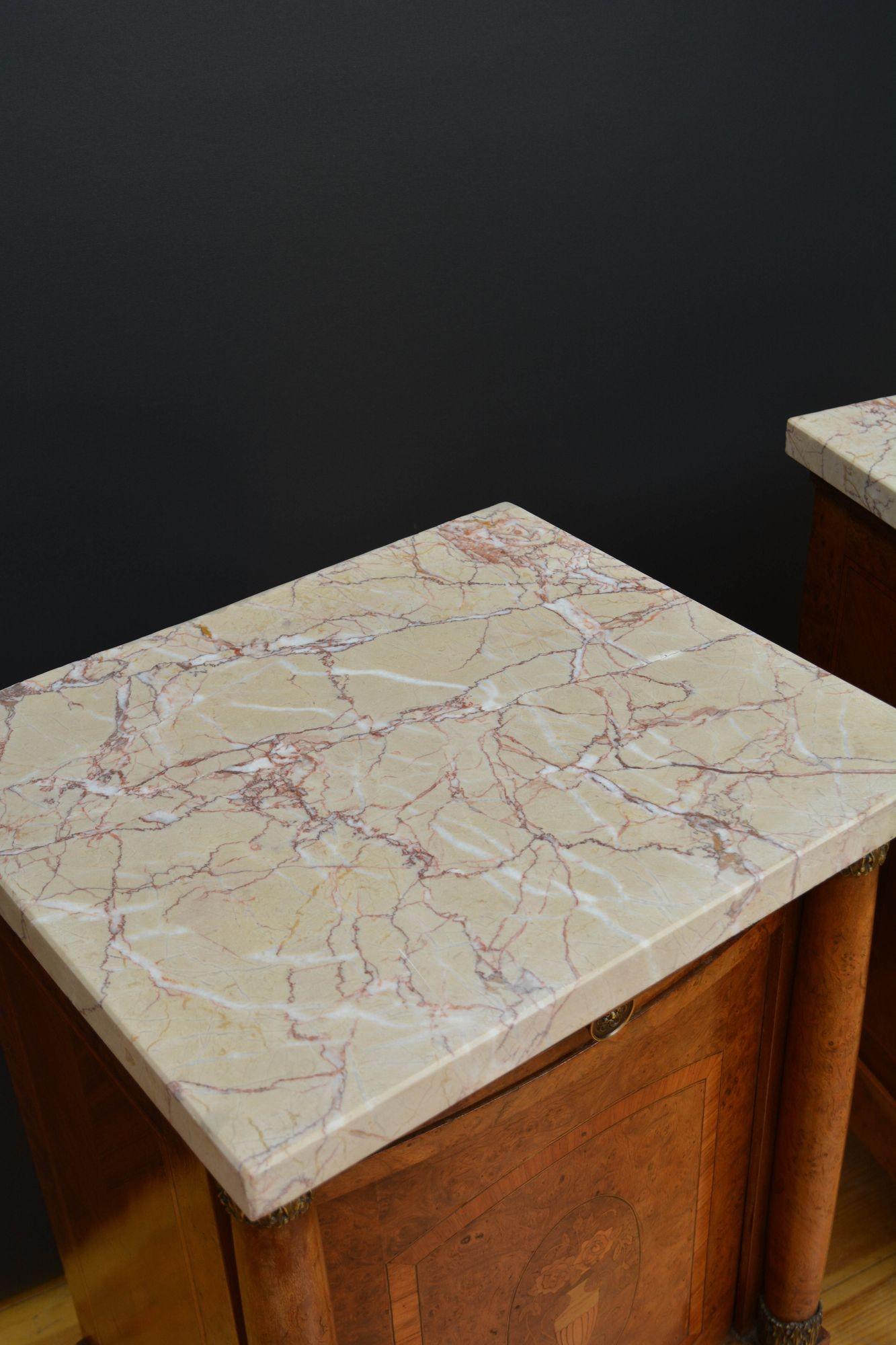 Sn5695 Pair of antique amboyna bedside cabinets of bow fronted design, each having attractive veined marble top above crossbanded drawer and finely inlaid doors enclosing storage space, all fitted with brass handles all flanked by columns with