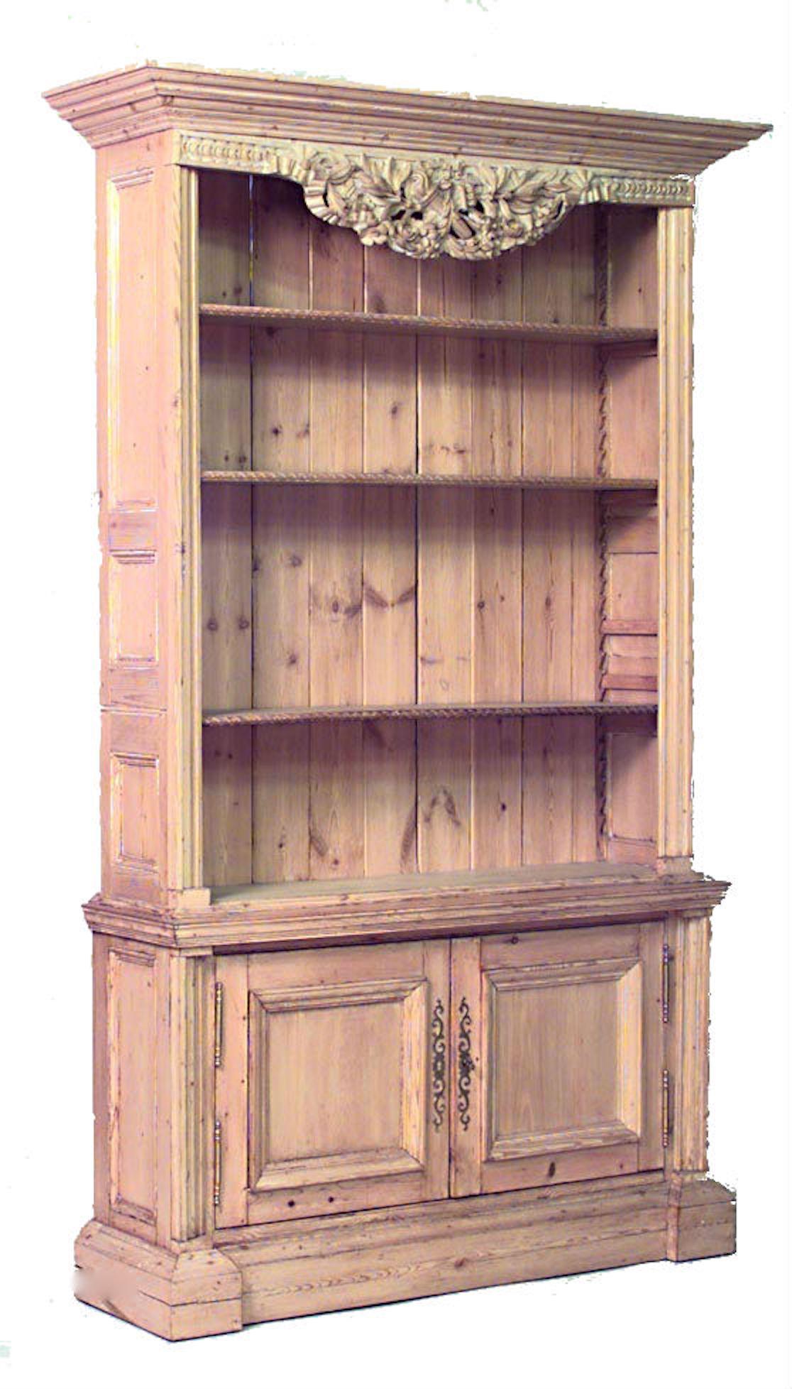 Pair of English Country (19/20th Century) stripped pine bookcase cabinets with open shelves and 2 lower doors with floral carved top. (PRICED AS Pair)
