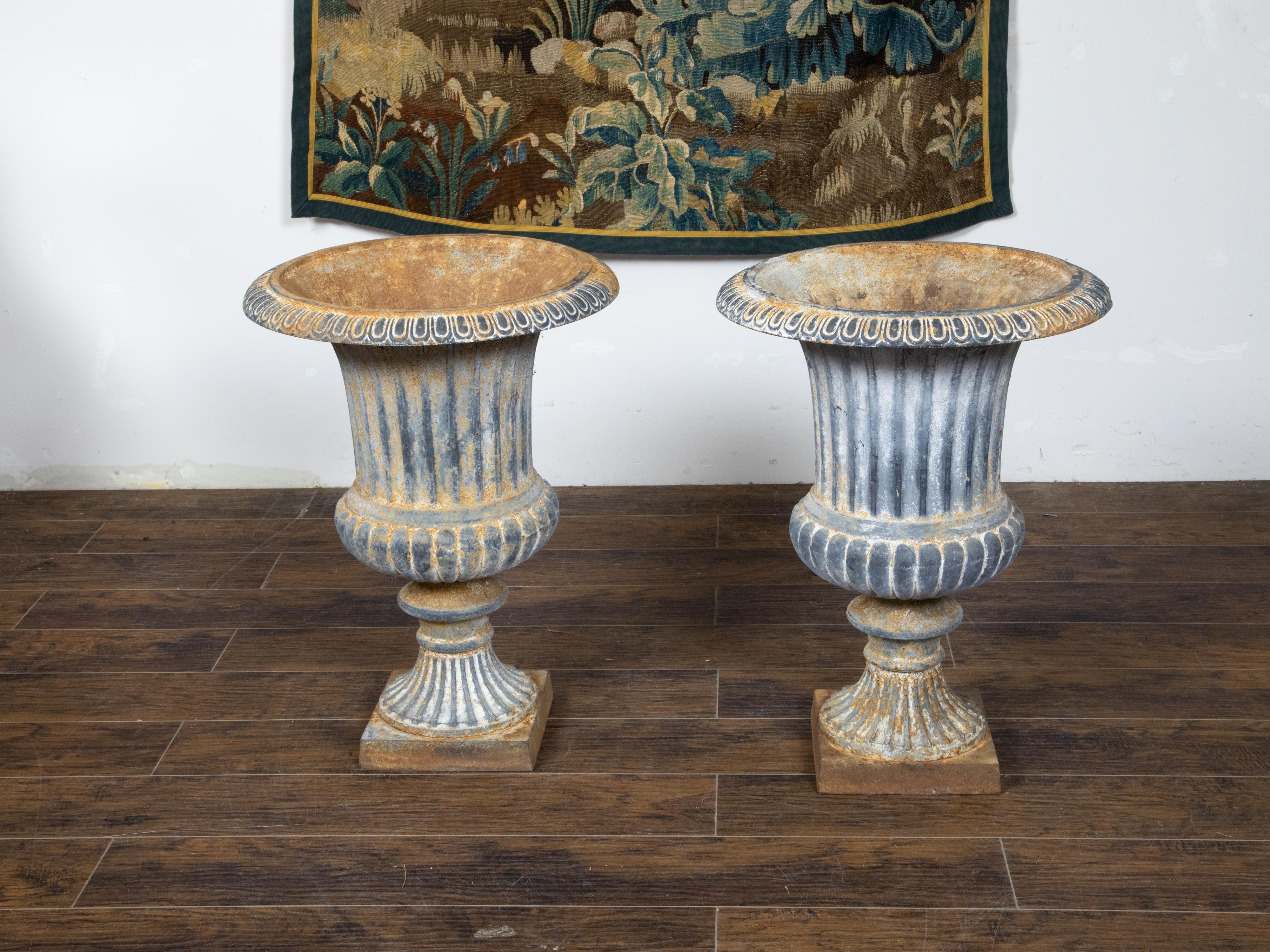 Pair of Turn of the Century French Medici Urn Cast Iron Planters with Patina In Good Condition For Sale In Atlanta, GA