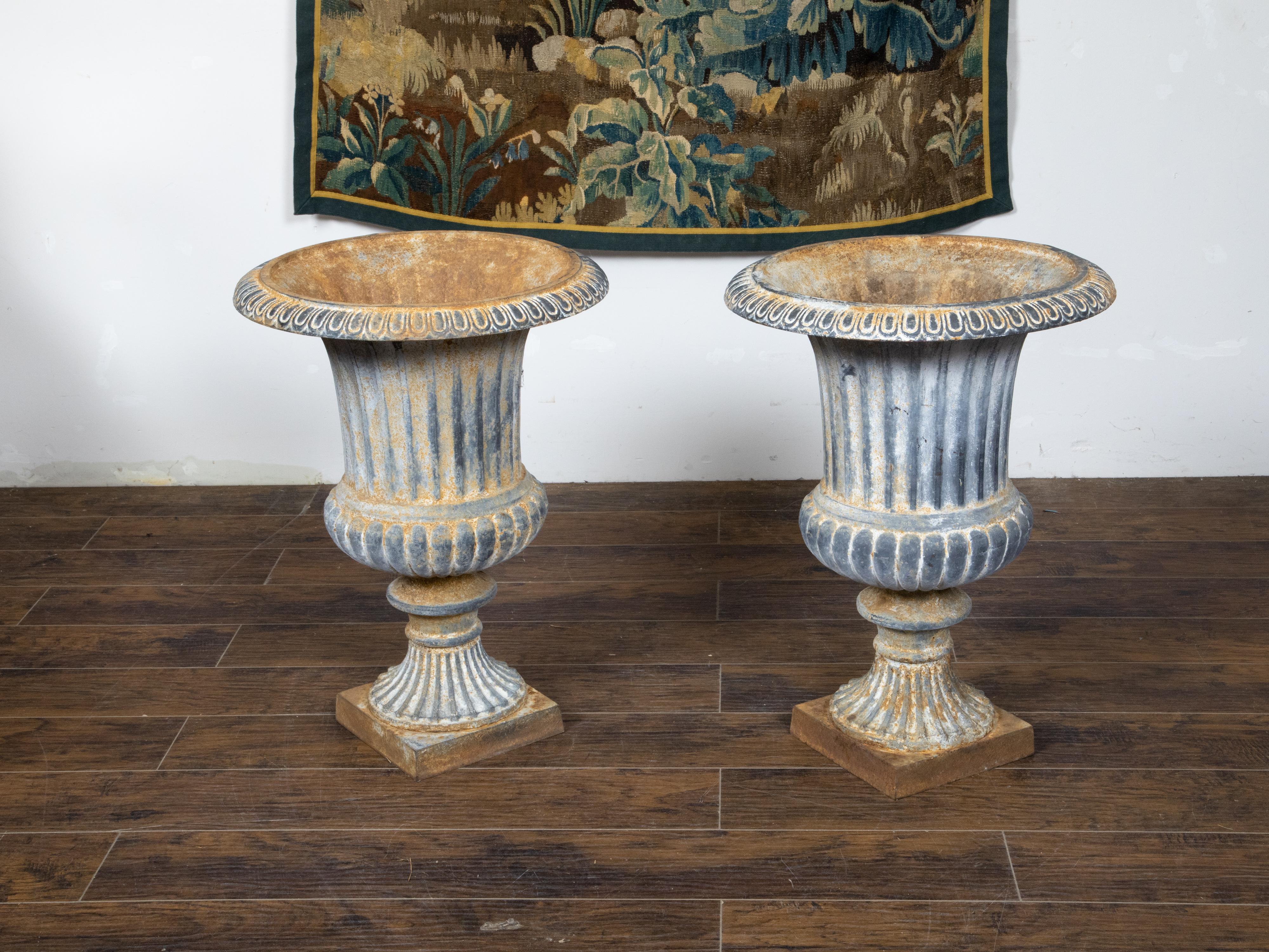20th Century Pair of Turn of the Century French Medici Urn Cast Iron Planters with Patina For Sale