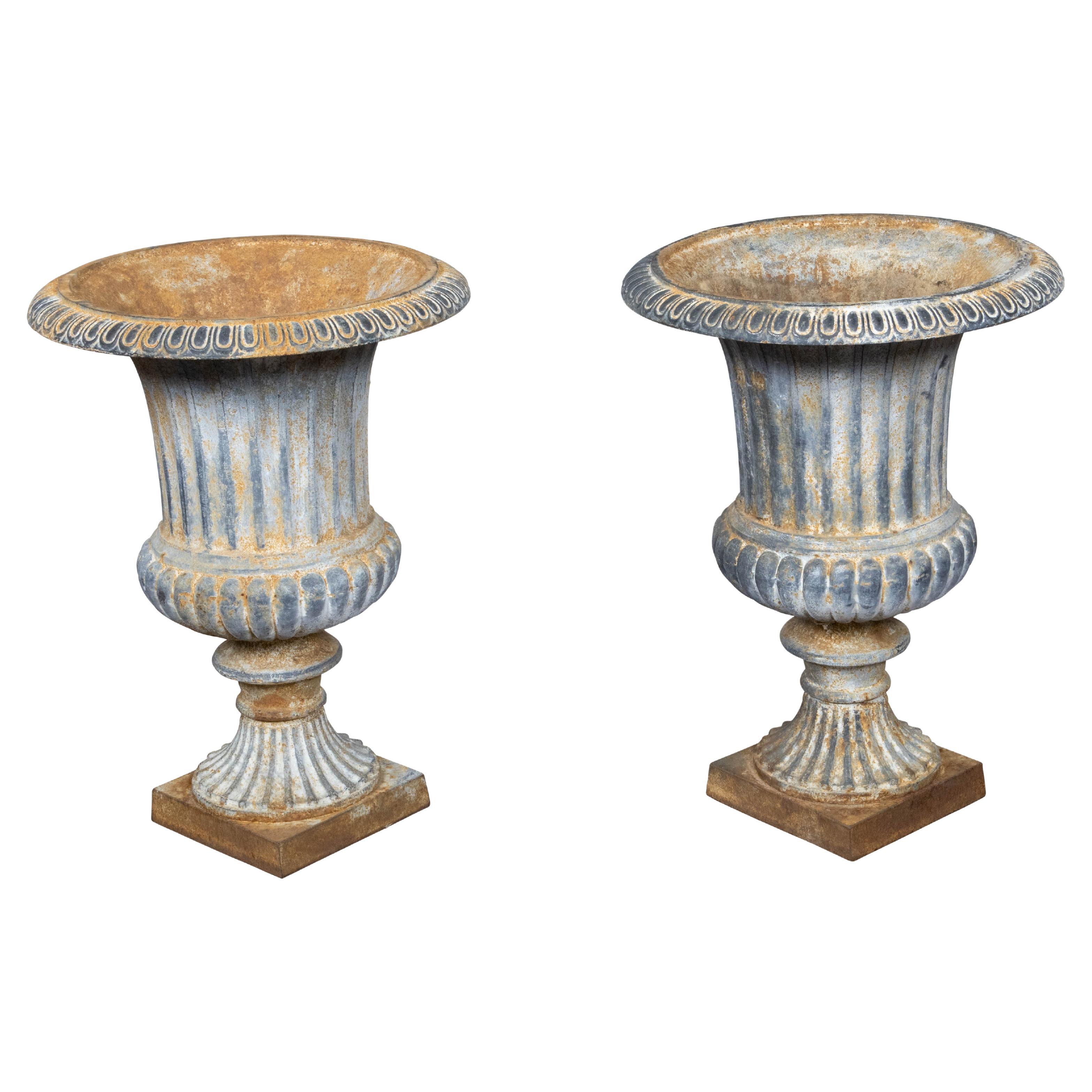 Pair of Turn of the Century French Medici Urn Cast Iron Planters with Patina For Sale