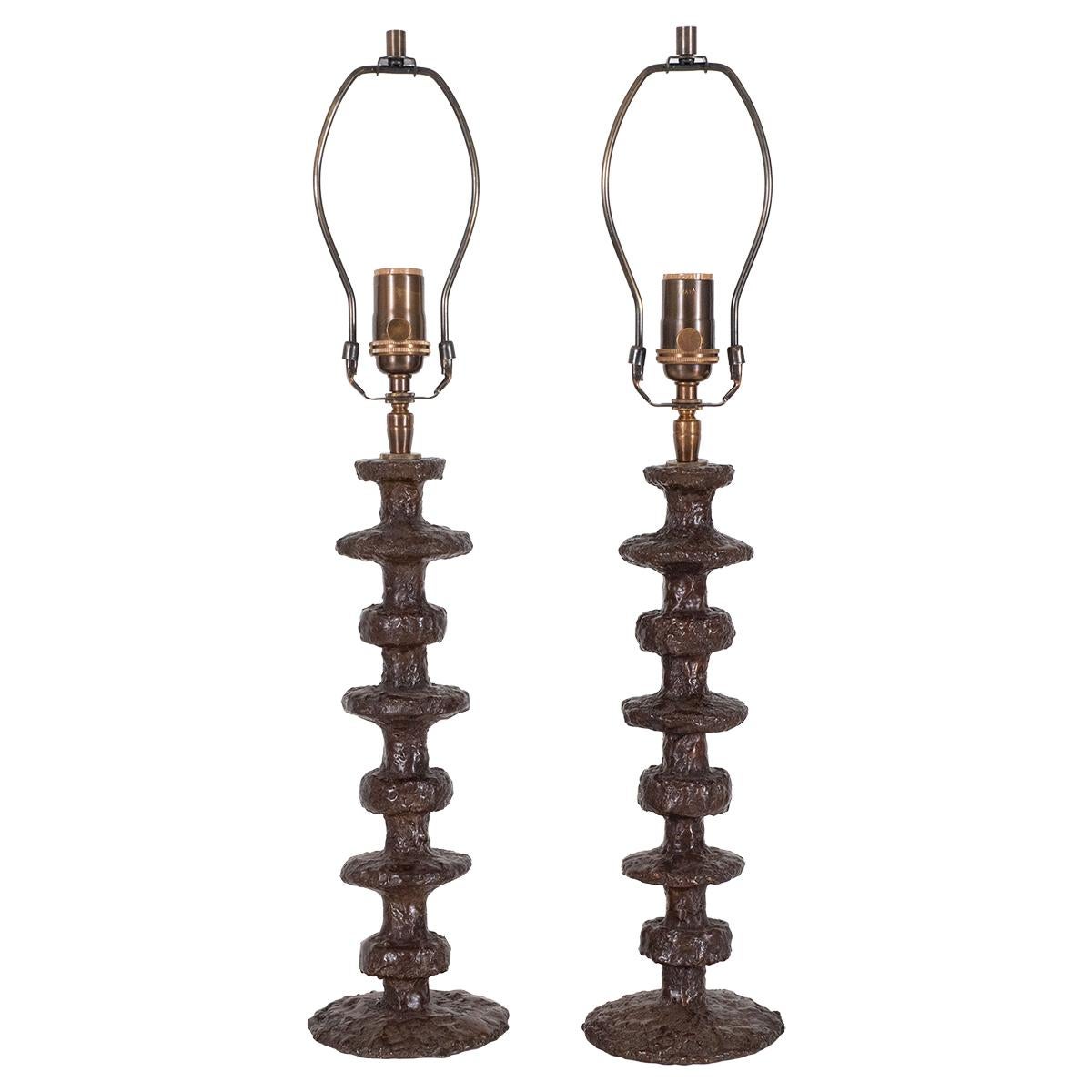 Pair of turned bronze table lamps by Claudio Gonzalez.