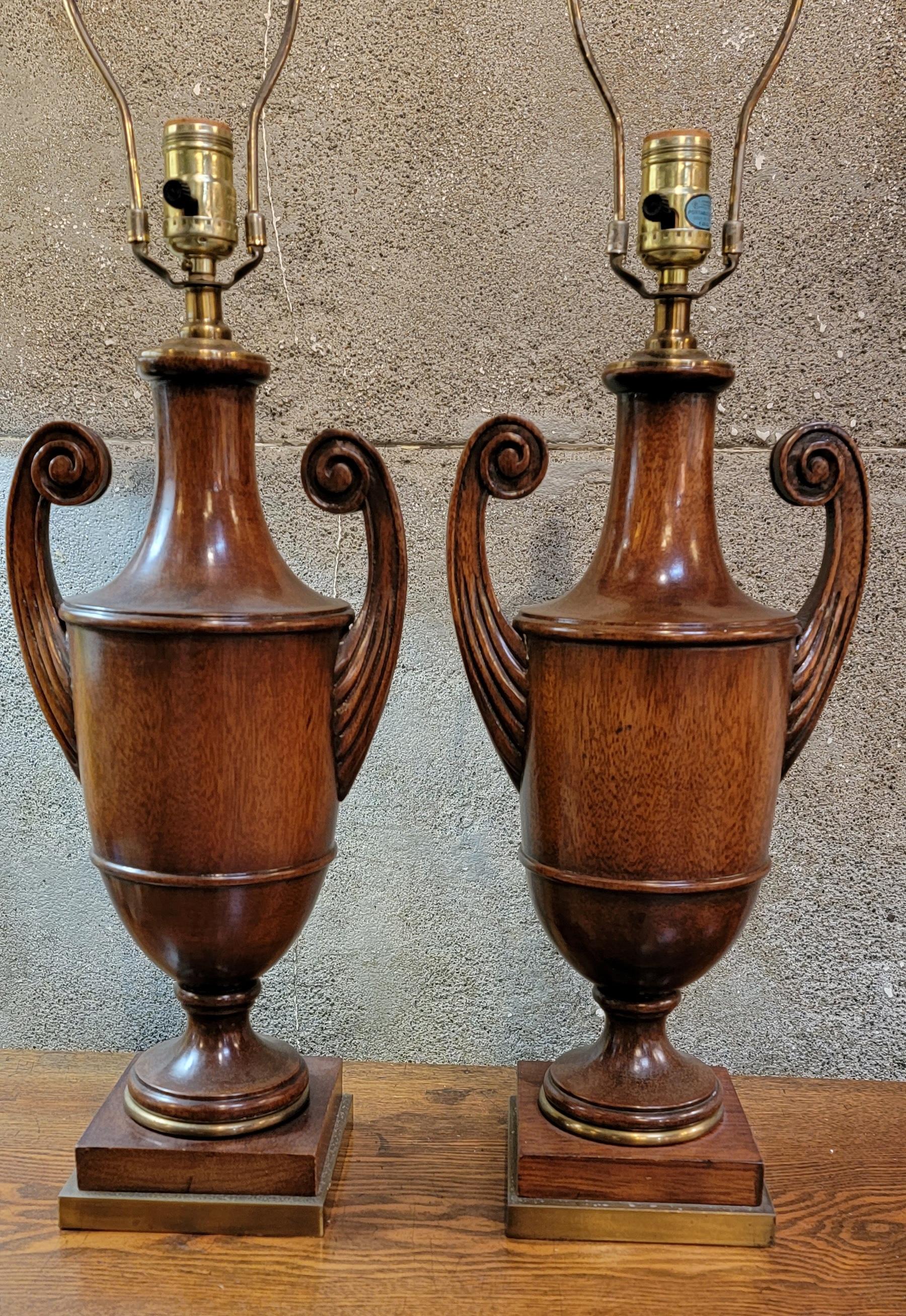 Elegant and fine pair of turned and carved solid mahogany table lamps. Each lamp measures 30