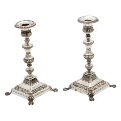 Pair of turned silver candlesticks with embossed floral motifs