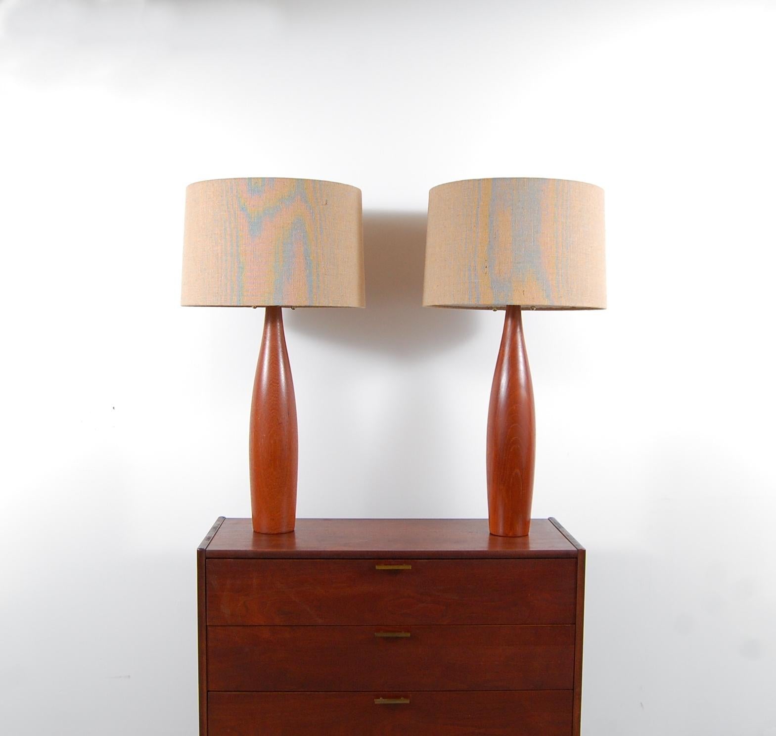 Pair of solid teak lamps by Esa Møbelvaerk, Denmark, circa 1958. Lamps have been completely re-wired for safety, and new top of the line brass hardware added, as well as brand new burlap shades. Lamps have also been dressed with brown, cloth wrapped