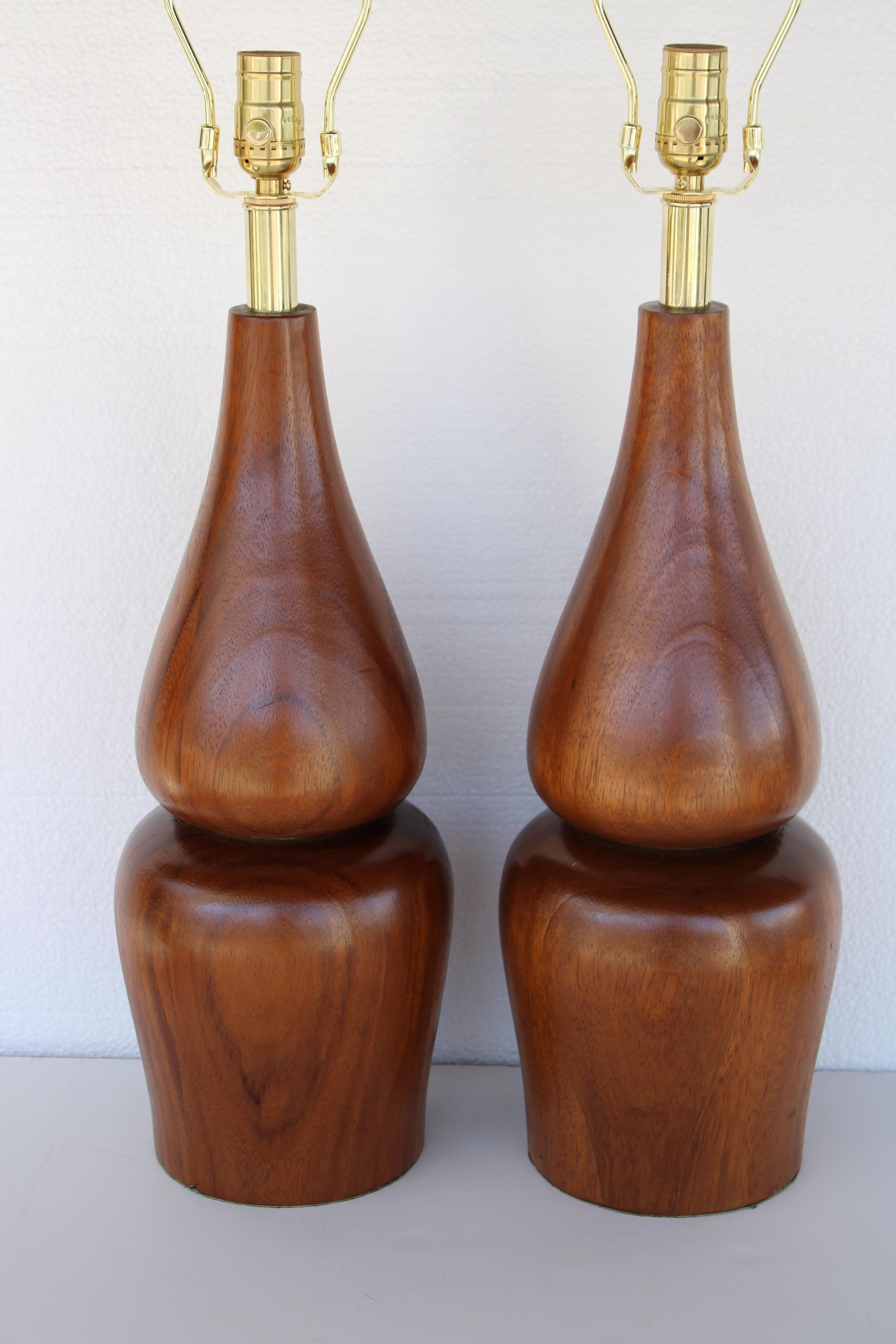 Pair of turned circular wood lamps.  Each lamp measures 21