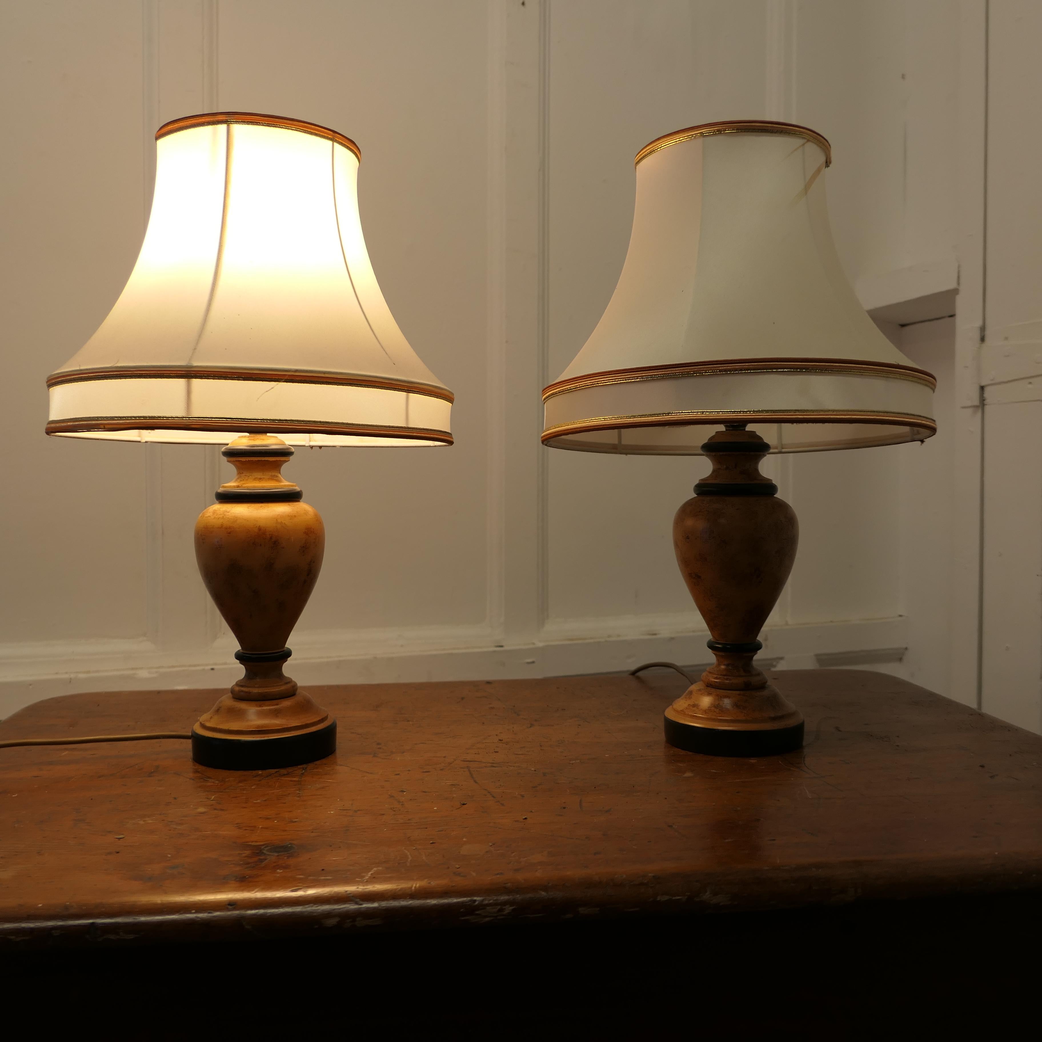 Pair of  Turned Wooden Table Lamps

These are a very stylish pair of  lamps, they are turned from wood which has been given a scumble finish in simulated Birds Eye maple
These are very attractive table lamps, they come with shades, the wiring is new