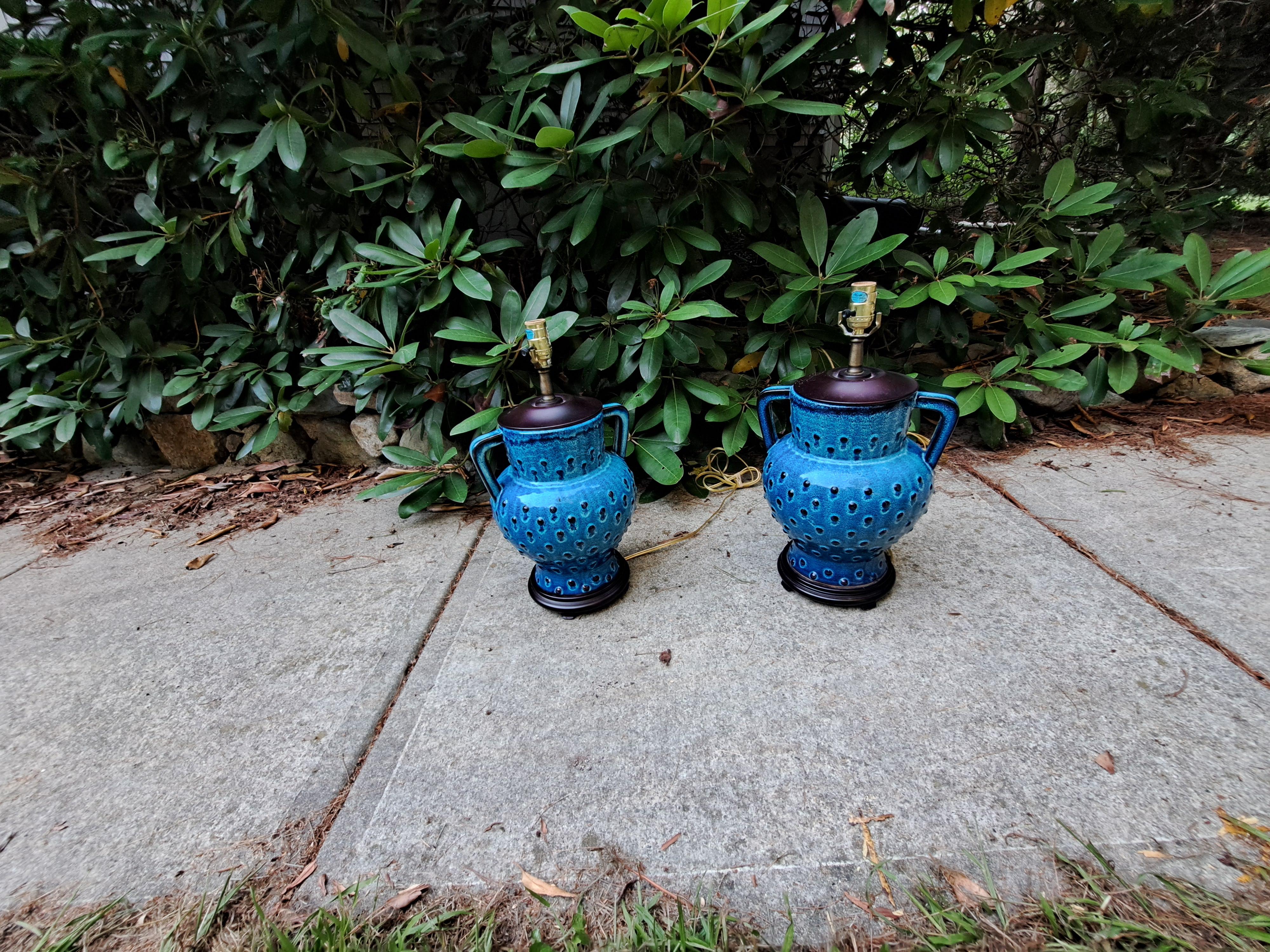 Pair of turquoise glaze ceramic table lamps with hobnail design and wood accents.  In the nouveau Asian lantern style attributed to Bitossi of Italy.