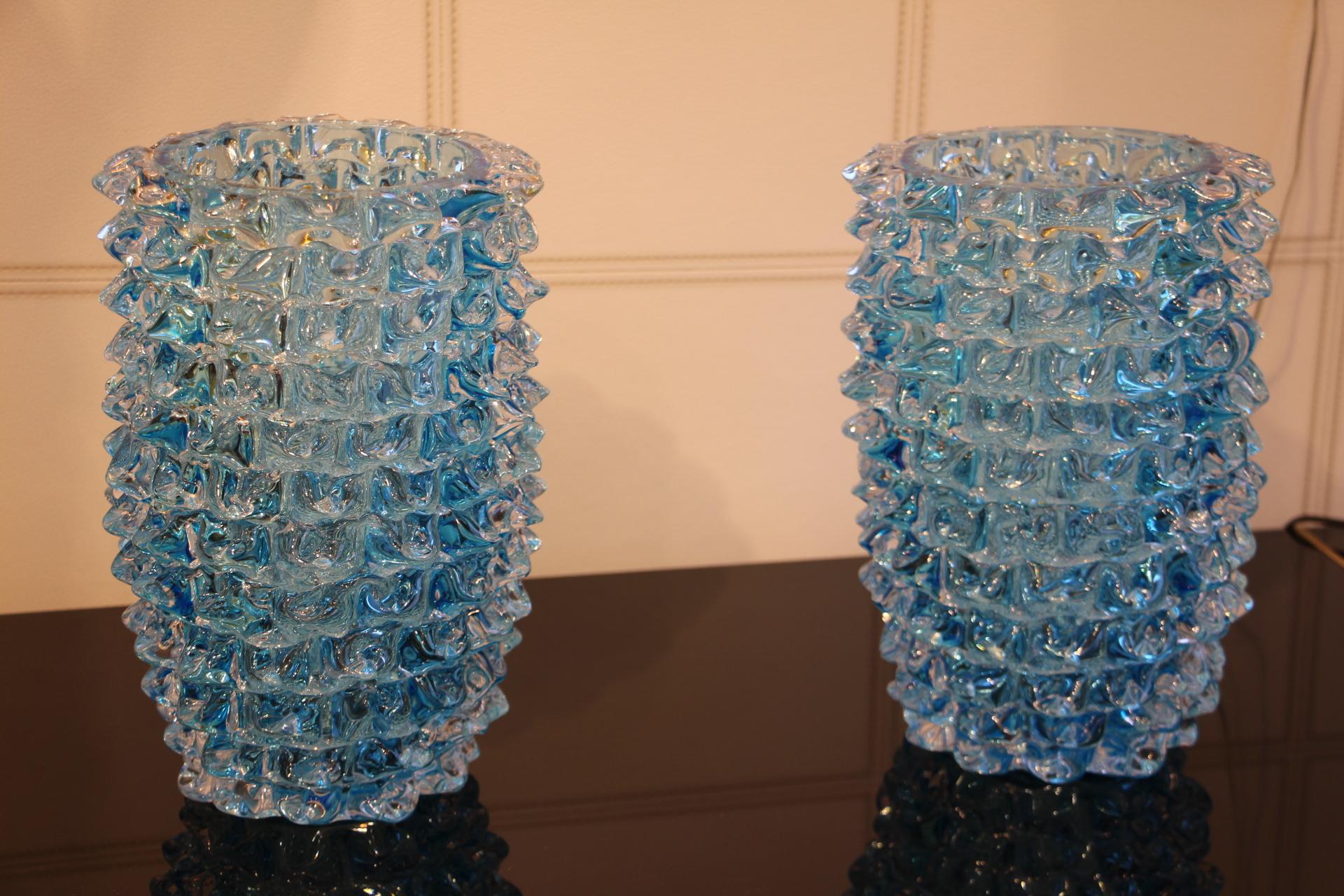 A spectacular pair of Venetian vases, imposing size in clear and turquoise blue blown Murano glass, hand decorated with the technique rostrato: spikes of glass individually pulled in relief.
Thick walled casing glass produces a lot of iridescent